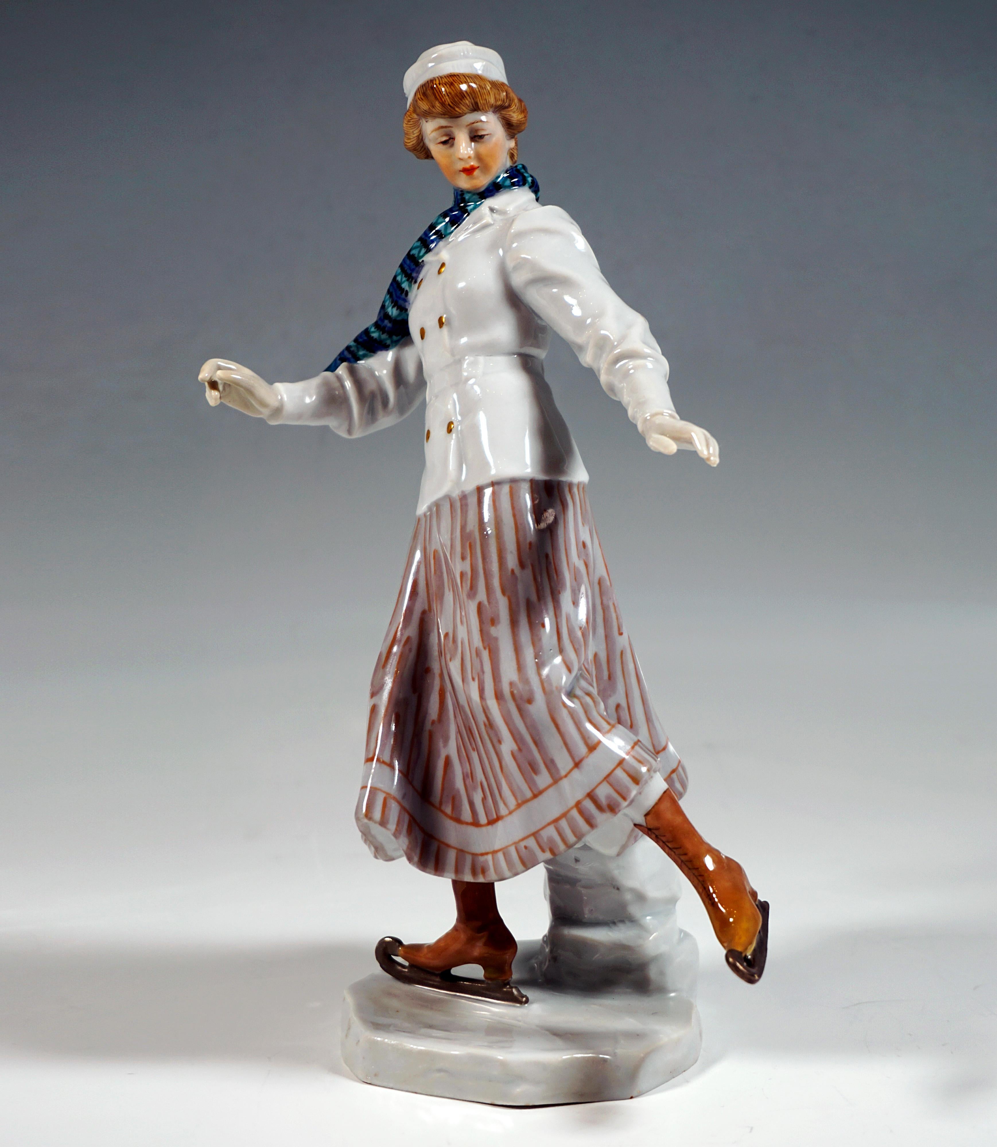 Rare Meissen Art Nouveau porcelain figure:
Skater in elegant winter clothes: lady wearing a long light gray skirt with light brown stripe decoration, white jacket with double-breasted gold buttons and matching belt, white hood on the upswept blond
