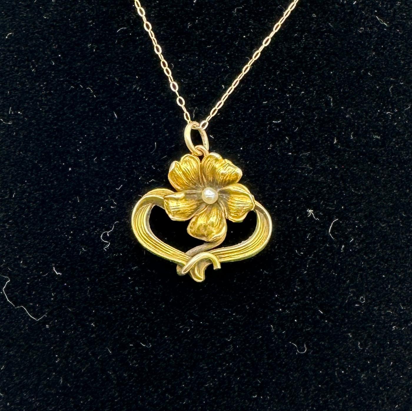 THIS IS A GORGEOUS VICTORIAN - ART NOUVEAU PENDANT IN THE FORM OF A BEAUTIFUL  FLOWER WITH A PEARL IN THE CENTER.  THE FLOWER IS SET IN AN ELEGANT GOLD RIBBON SURROUND WITH LOVELY ART NOUVEAU DESIGN.  THE PENDANT IS 10 KARAT YELLOW GOLD.  THIS IS