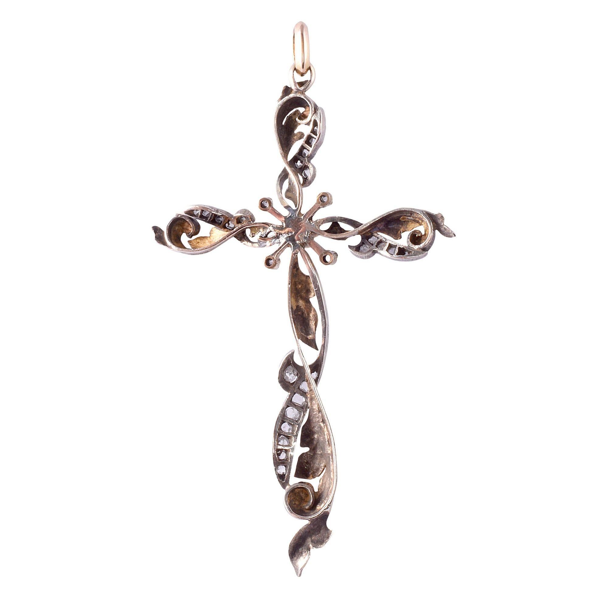 Antique Art Nouveau foliate pearl & diamond cross pendant, circa 1915. This antique cross pendant is crafted in 18 karat gold and silver in a foliate design. The Art Nouveau cross features 27 rose cut diamonds and a 5.85mm pearl center. [KIMH