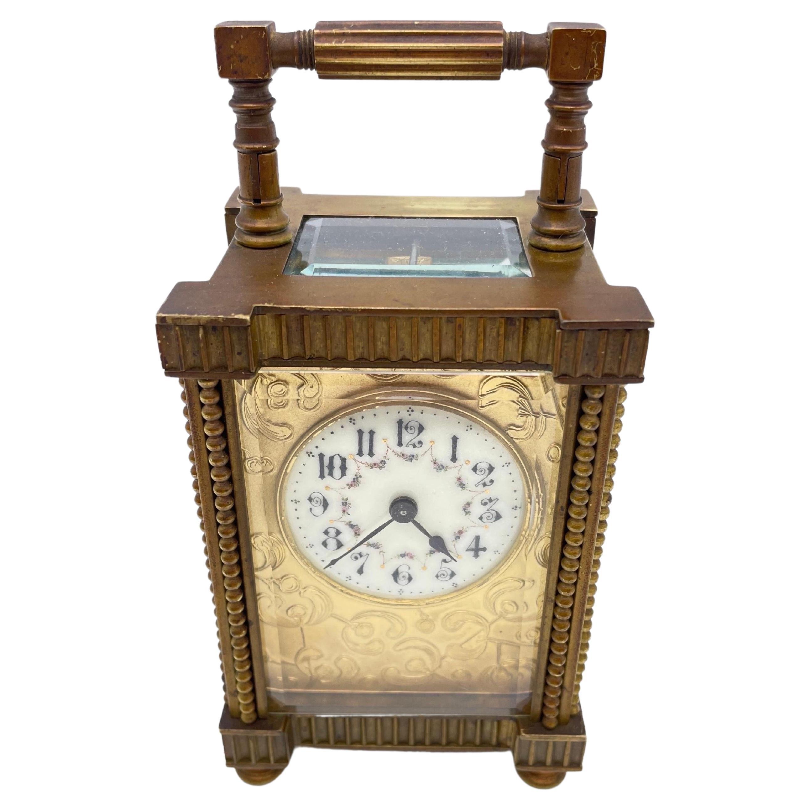 Travel alarm clock in a high-quality brass case
 With facet-cut enamelled glass and hand-painted dial  
the clockwork has to be taken over by the buyer himself and made to run
