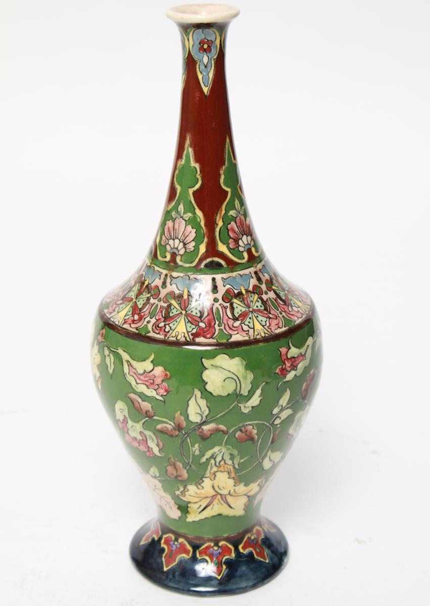 Art Nouveau 'Old Dutch' vase by Franz Anton Mehlem for Royal Bonn, created, circa 1910 with a green and brown glazed body with hand-painted flowers, leaves, buds and geometric pattern. The underside has hand-painted mark 