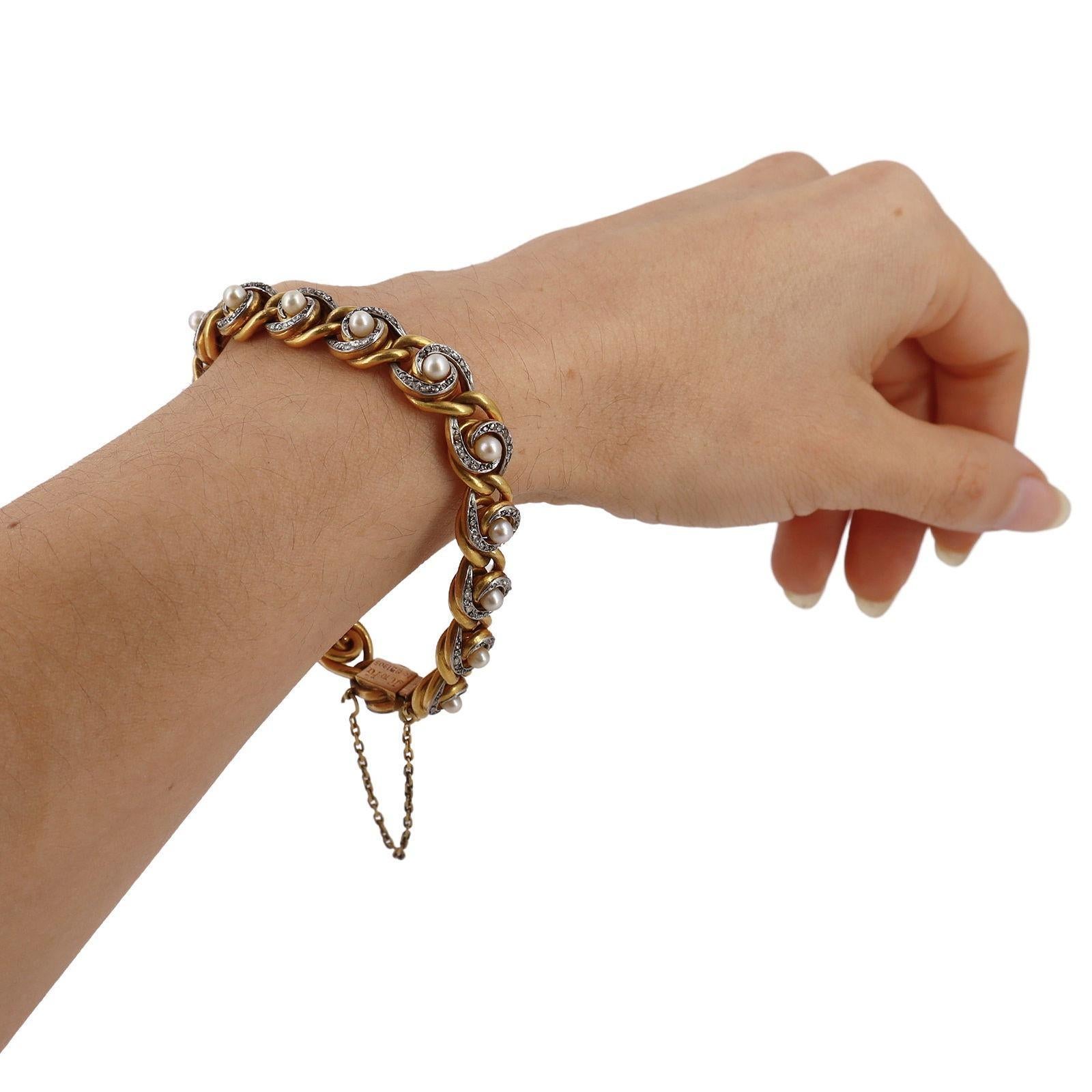 This exceptional handcrafted bracelet, created during the Art Nouveau era in France, is made from 18kt yellow gold with intricate platinum detailing. Adorned with 16 round cream natural pearls and natural rose-cut diamonds totaling approximately