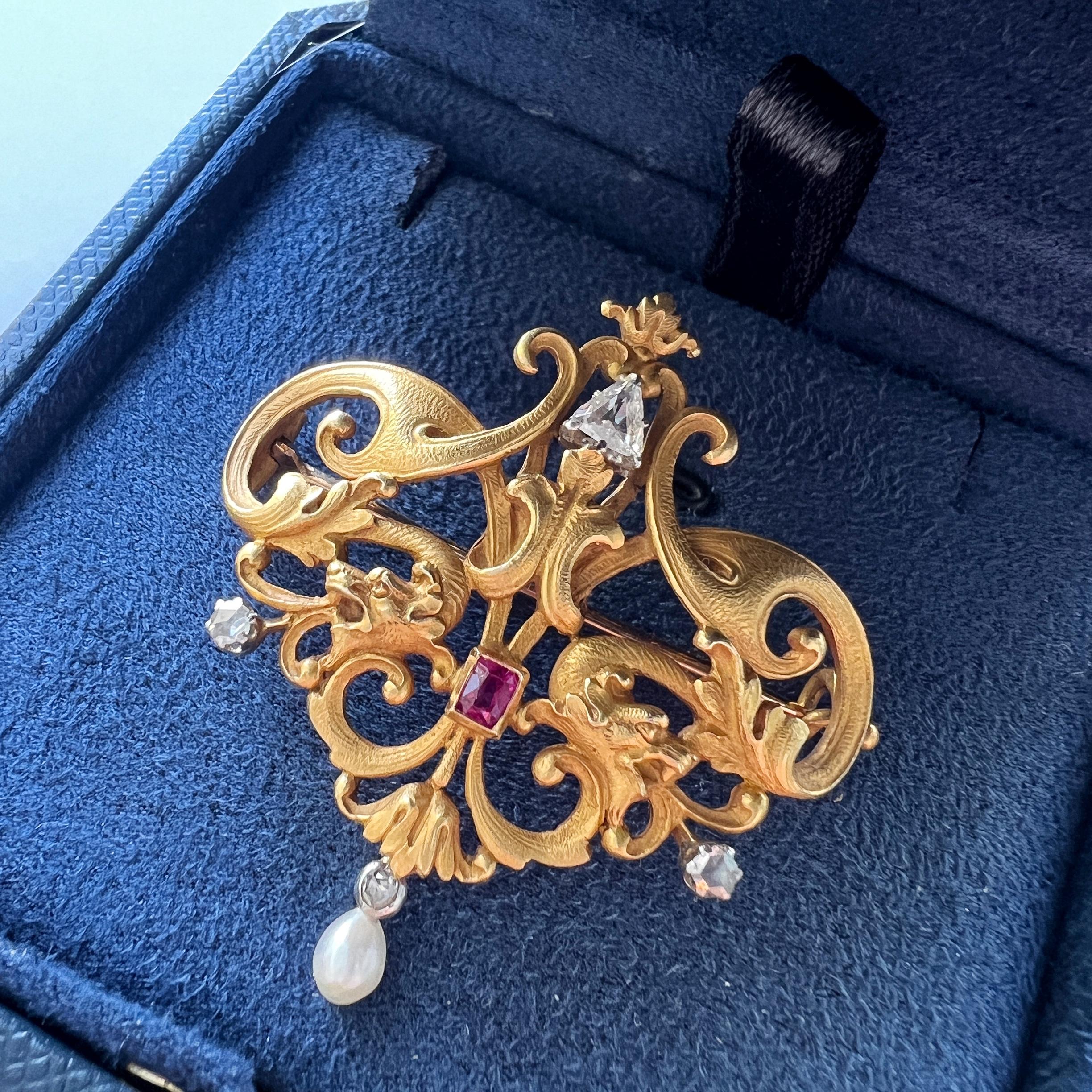 Let’s step into the enchanting world of the Art Nouveau era with this exceptionally rare and captivating French-made double chimera pendant brooch. Crafted with unparalleled skill, this piece seamlessly weaves together the essence of nature and