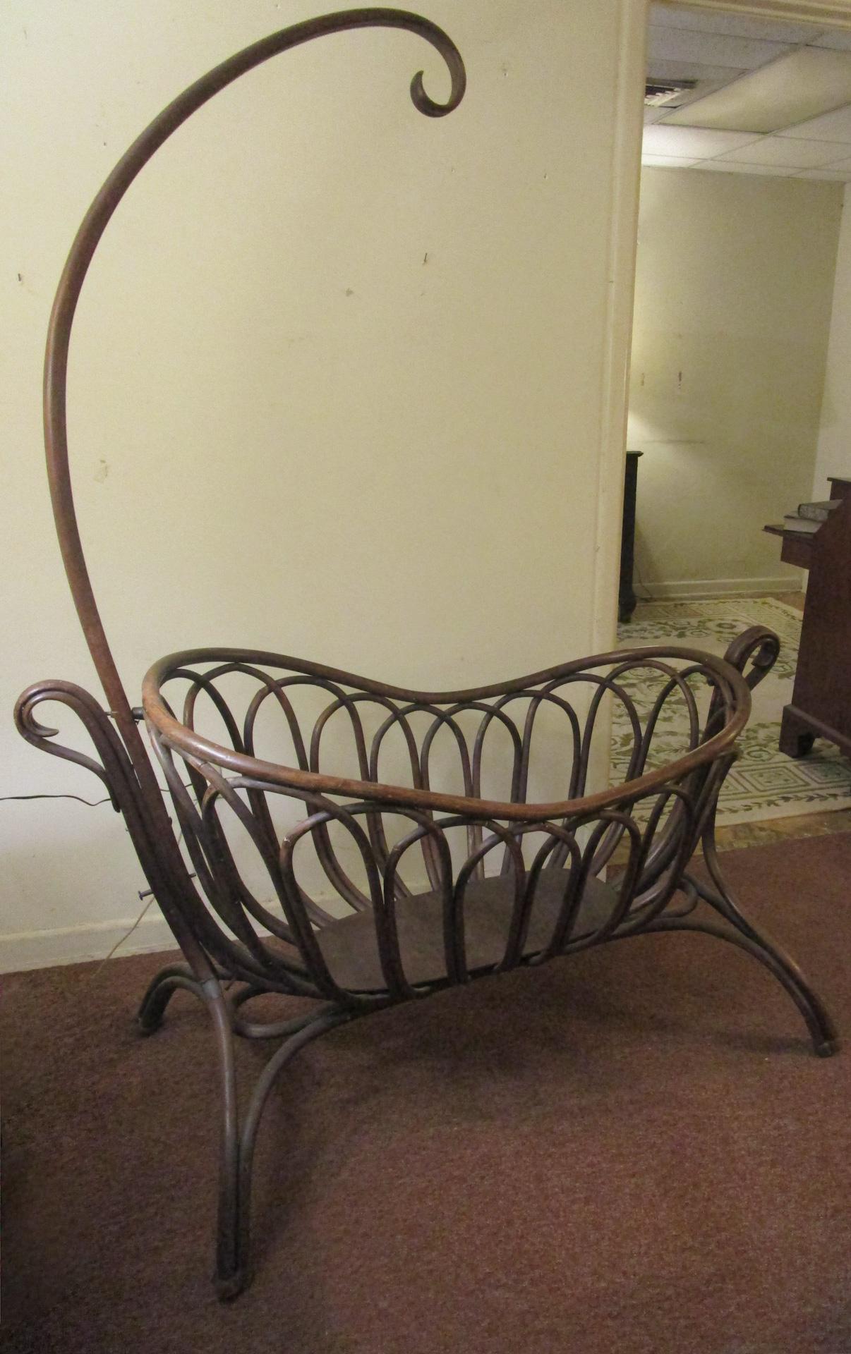 This very graceful French bentwood rocking cradle with canopy is from the Art Nouveau period (1890-1910) and is done in the style of the German-Austrian designer Michael Thonet who developed this type of furniture in order to make it appealing,