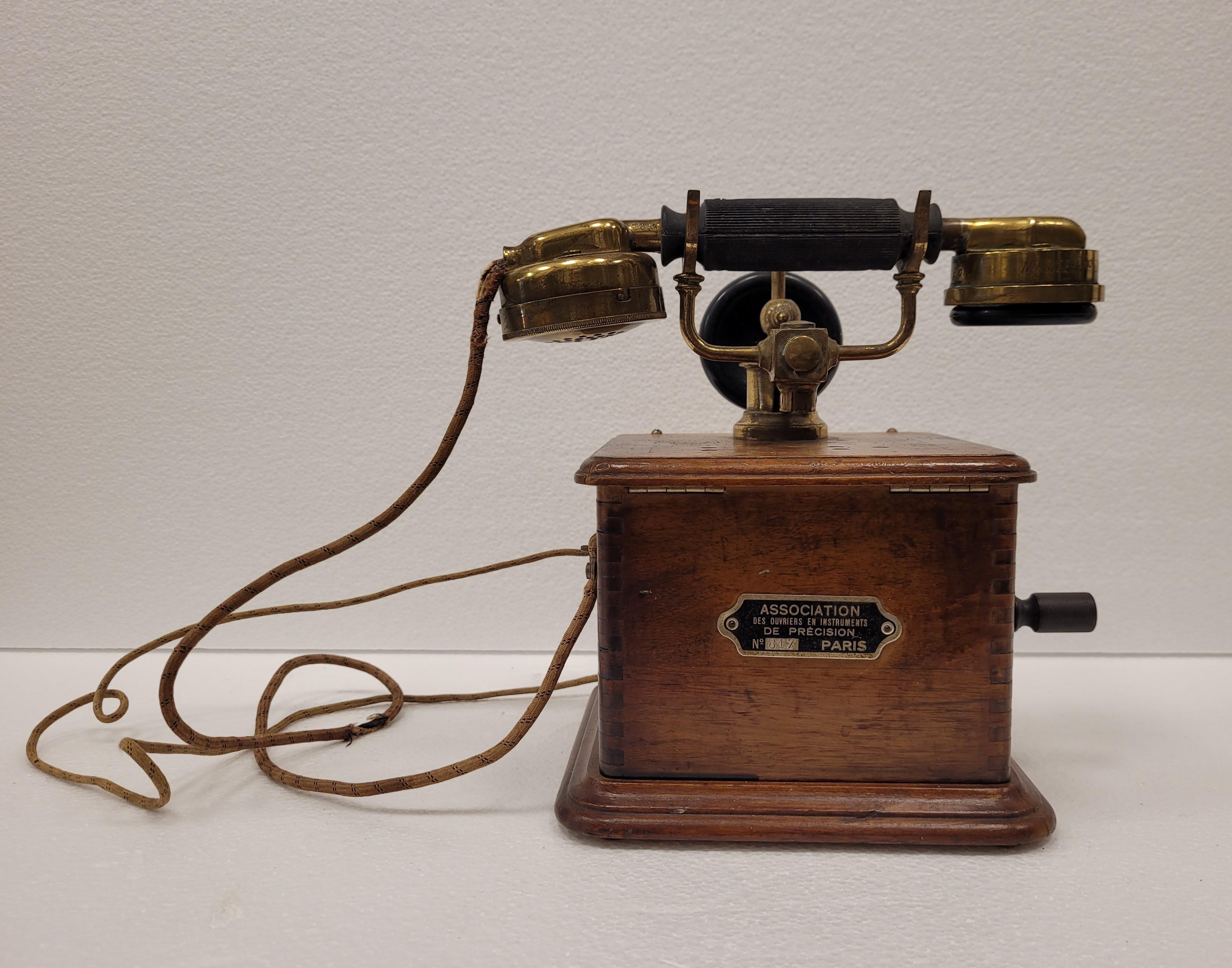 Amazing Art Nouveau black and wooden  French Telephone, by AOIP.
 At the end of the 19th century, sixty-four workers from the Paris Chamber of Precision Instrument Workers came together to create their company. It was the secretary of this union