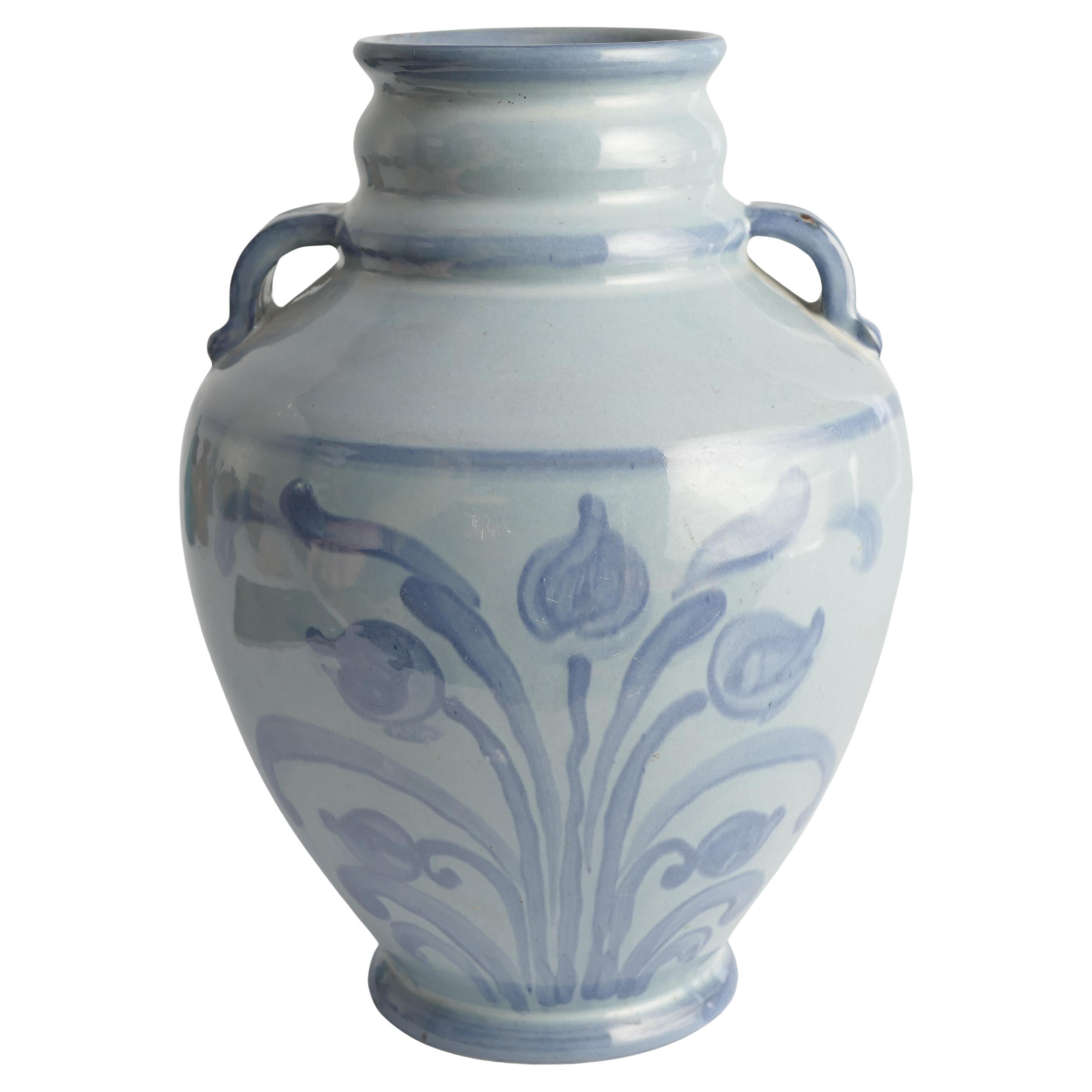 A stunningly beautiful art nouveau french blue floral motif vase with handles by Upsala Ekeby, Sweden 19 the 1920s. The floral motif is painted with free hand on two sides of the vase.

Painted on the bottom with 