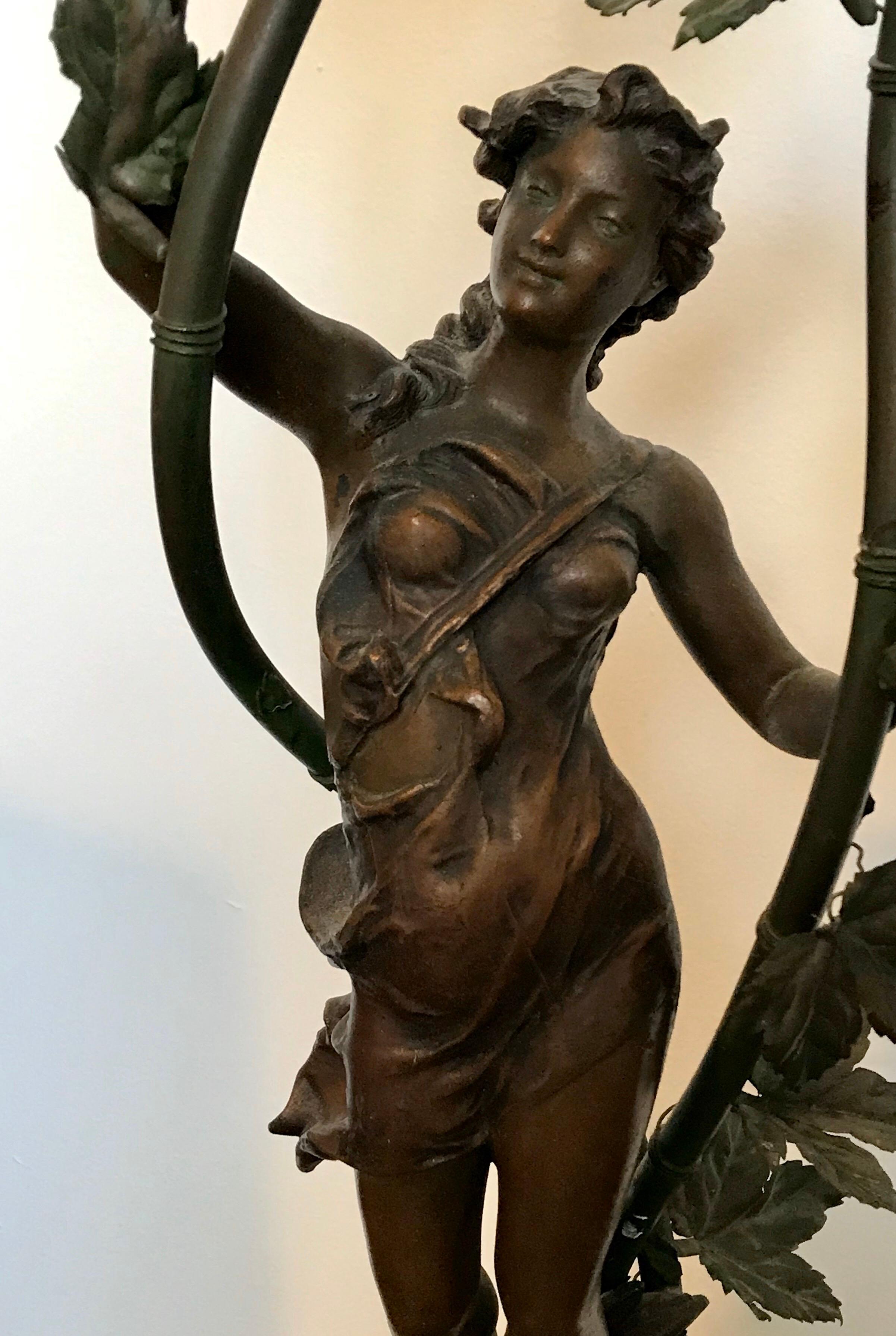 Beautiful bronze figurine lamp with floral leaf accents by Ernest Justin Ferrand.