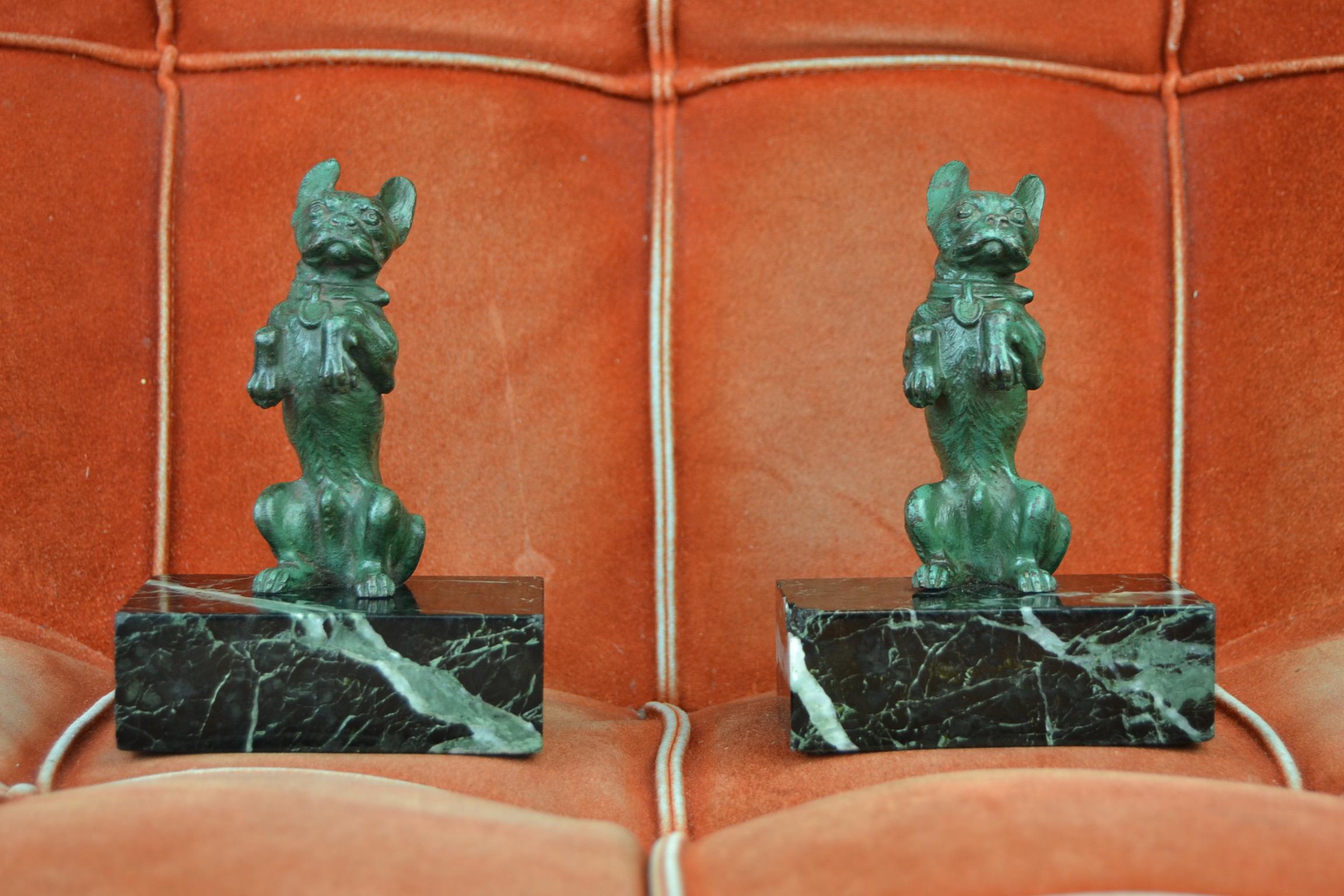 Great looking set of Art Nouveau bookends with French bulldogs. 
These patinated bronze dog sculptures are mounted on marble bases. 
The dogs are very detailed and are standing on their hind legs. 

The marble has the color black with green and