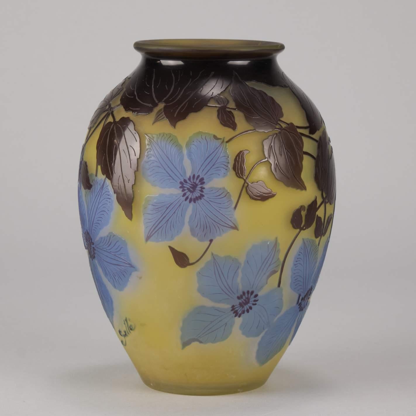An attractive late 19th century cameo glass vase of rounded form acid cut with decorative blue clematis flowers on burgundy branches against a deep yellow background with excellent hand finished detail and colour, signed Galle in cameo and with