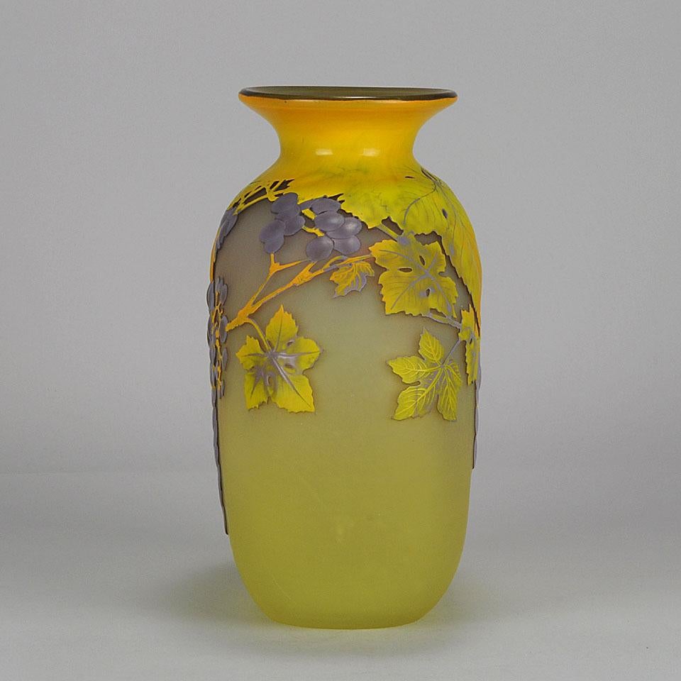 A very vibrant and unusual early 20th century French soufflé vase of spherical form, the blue and purple flowering berry landscape draped delicately against a yellow field. Exhibiting excellent colour and very fine detail, signed Gallé.

Emile