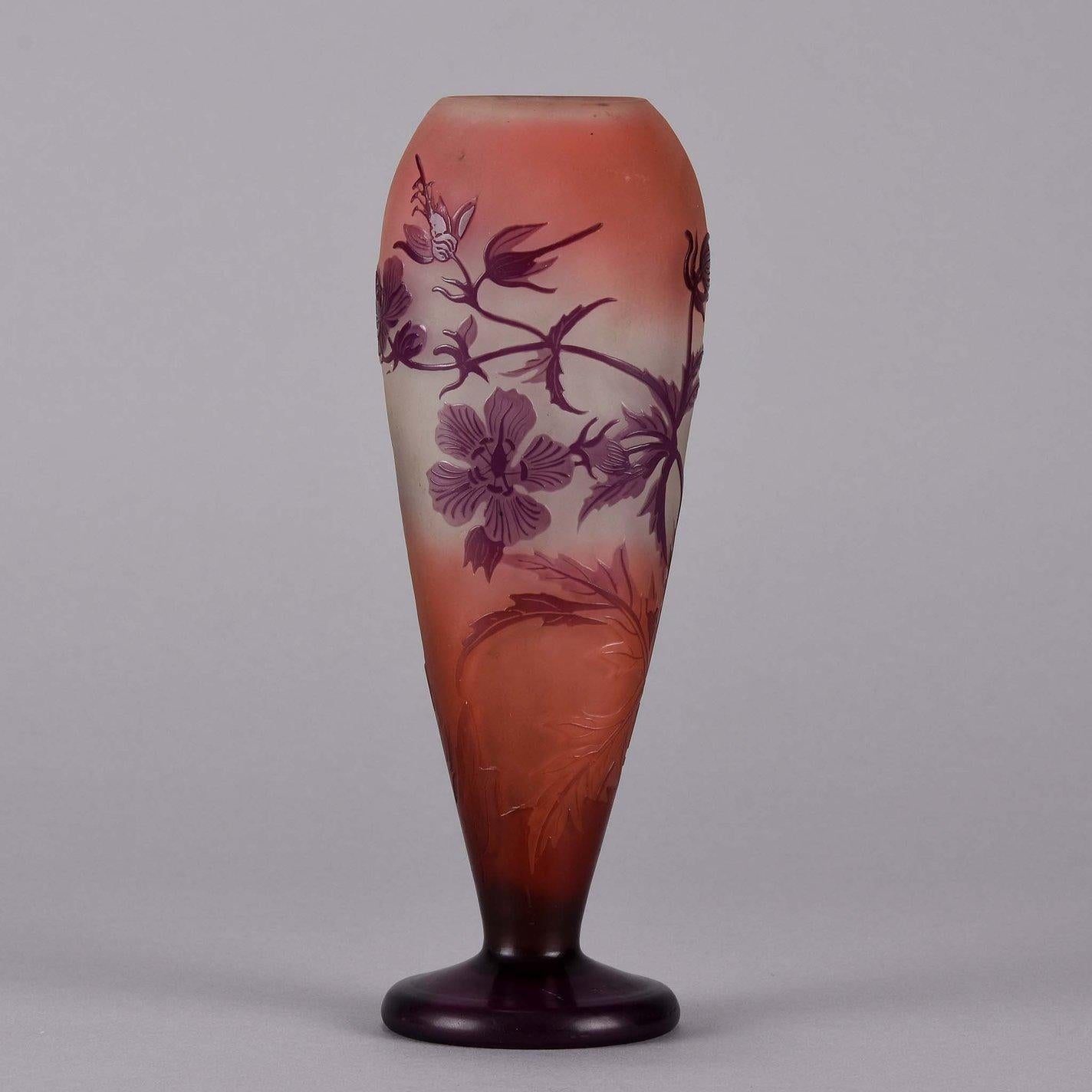 Delightful Art Nouveau French cameo glass vase overlaid with decorative pink and purple Floral design on a cream peach field. A very fine vase exhibiting excellent color and detail, signed Gallé

Emile Gallé, 1846–1904 is considered a driving