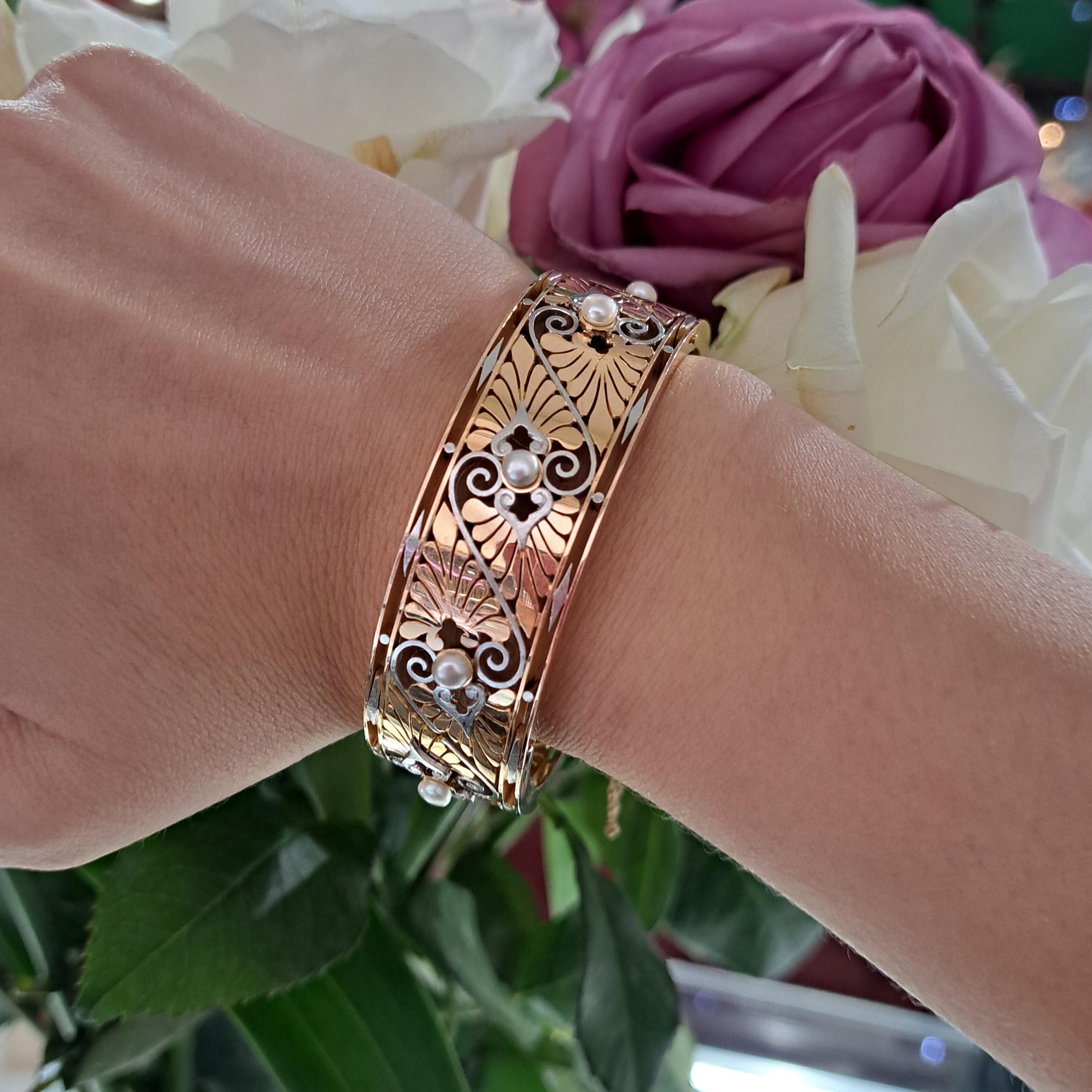 A French, antique, Greek Revival, pearl gold and platinum bangle, with a repeat pattern of bouton pearls, individually set between motifs of opposing gold acanthus leaves, divided by platinum scrolls, bordered by knife edges, with dot and lozenge