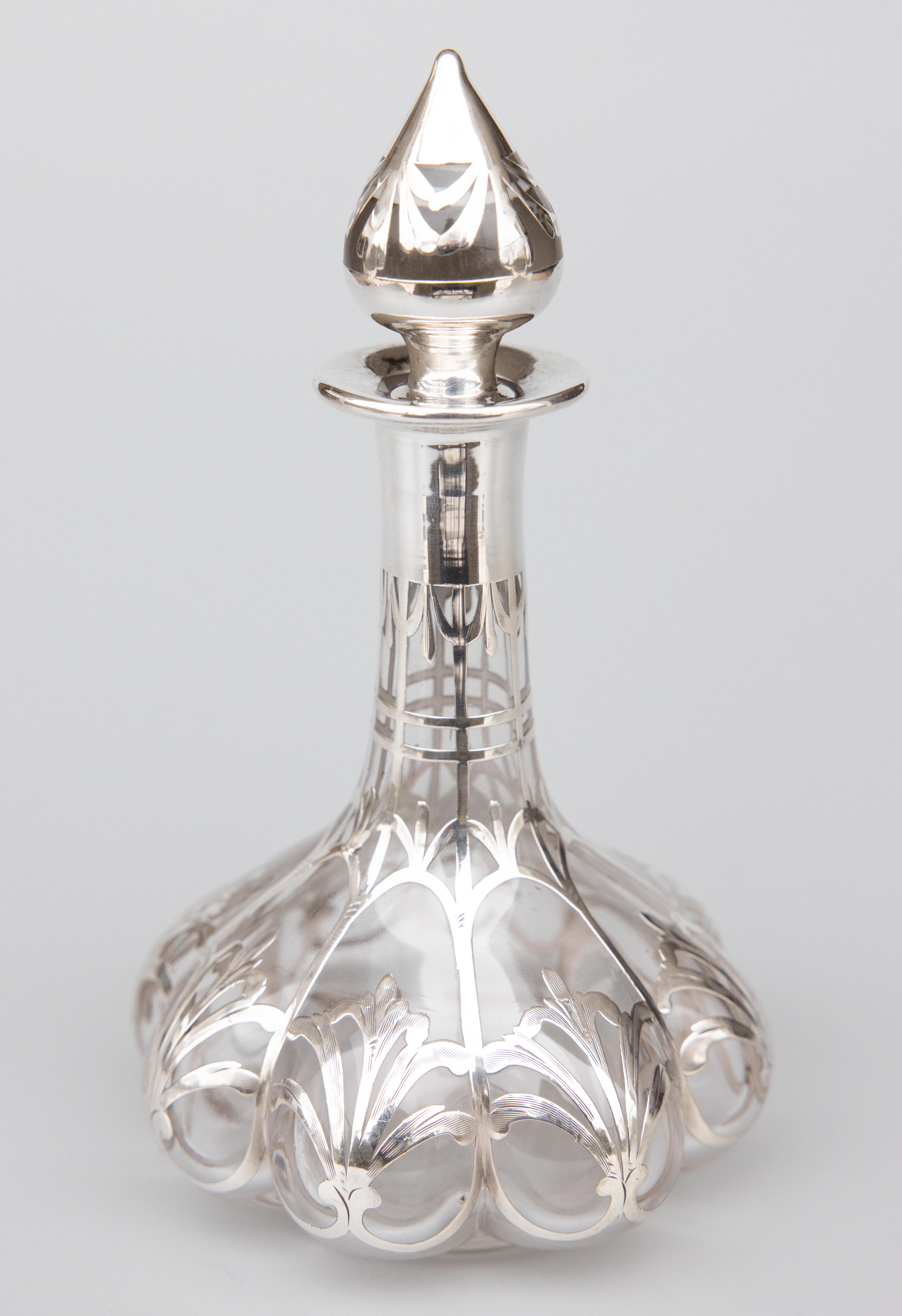 A beautiful antique French silver overlay glass perfume cologne bottle with stopper, circa 1900. It has a gorgeous lobed shape and stylish Art Nouveau design and would be lovely on a dresser or vanity.

Dimensions
4