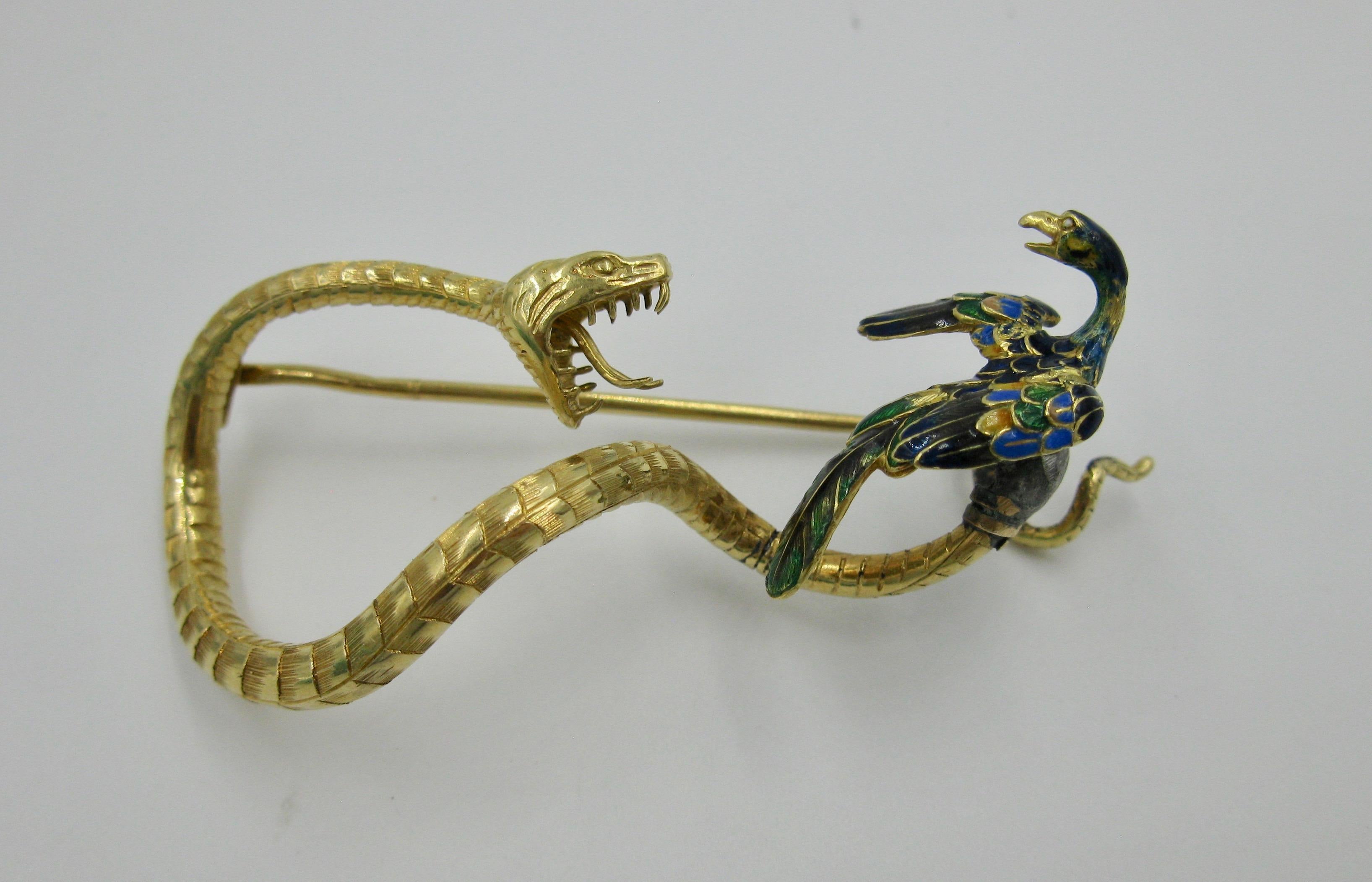 AN ABSOLUTELY STUNNING AND VERY RARE FRENCH ART NOUVEAU BROOCH OF AN OPEN MOUTH SNAKE AND A GORGEOUSLY ENAMELED PHOENIX BIRD.  THE BROOCH IN 18K YELLOW GOLD WITH MAGNIFICENT DETAILS AND MASTERFUL CRAFTSMANSHIP.  IT DATES TO THE FIRST QUARTER OF THE
