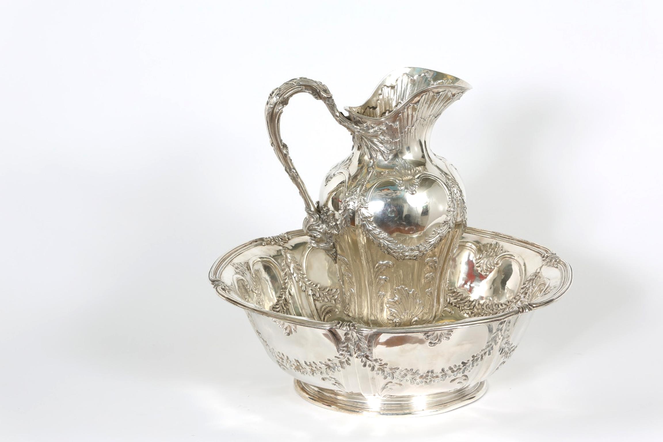 Early 20th century Art Nouveau French tetard sterling wash basin and jug . The silver pedestal jug is decorated with exterior foliate swags and scrolls design details with multi tiered ruffed edge decoration . The handle is also designed with