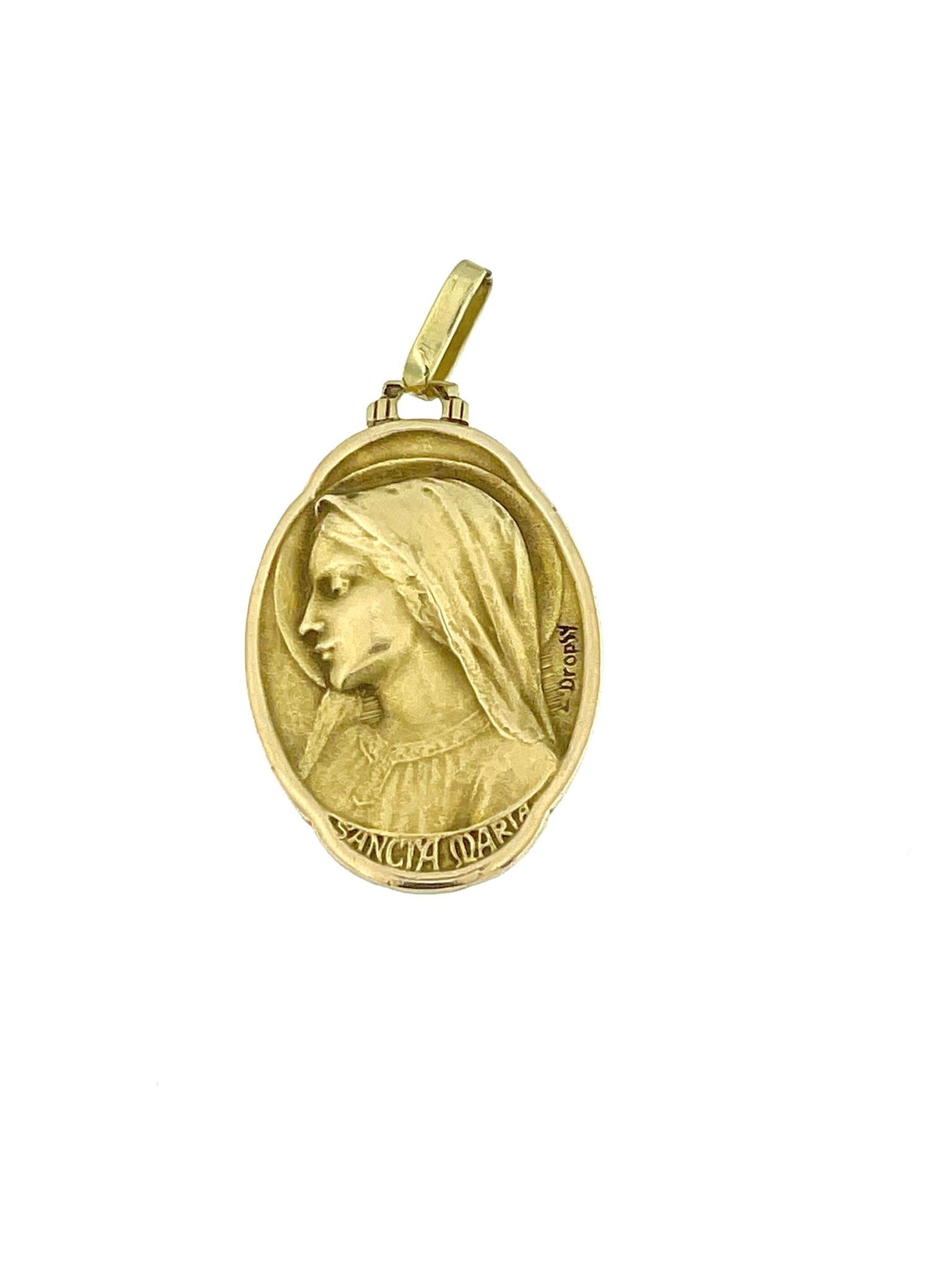 The Art Nouveau French Yellow Gold Virgin Mary Pendant, signed by E. Dropsy, is a remarkable piece of religious jewelry with a touch of artistic flair. Crafted from 18-karat yellow gold, it exudes elegance and sophistication.

The Virgin Mary, a