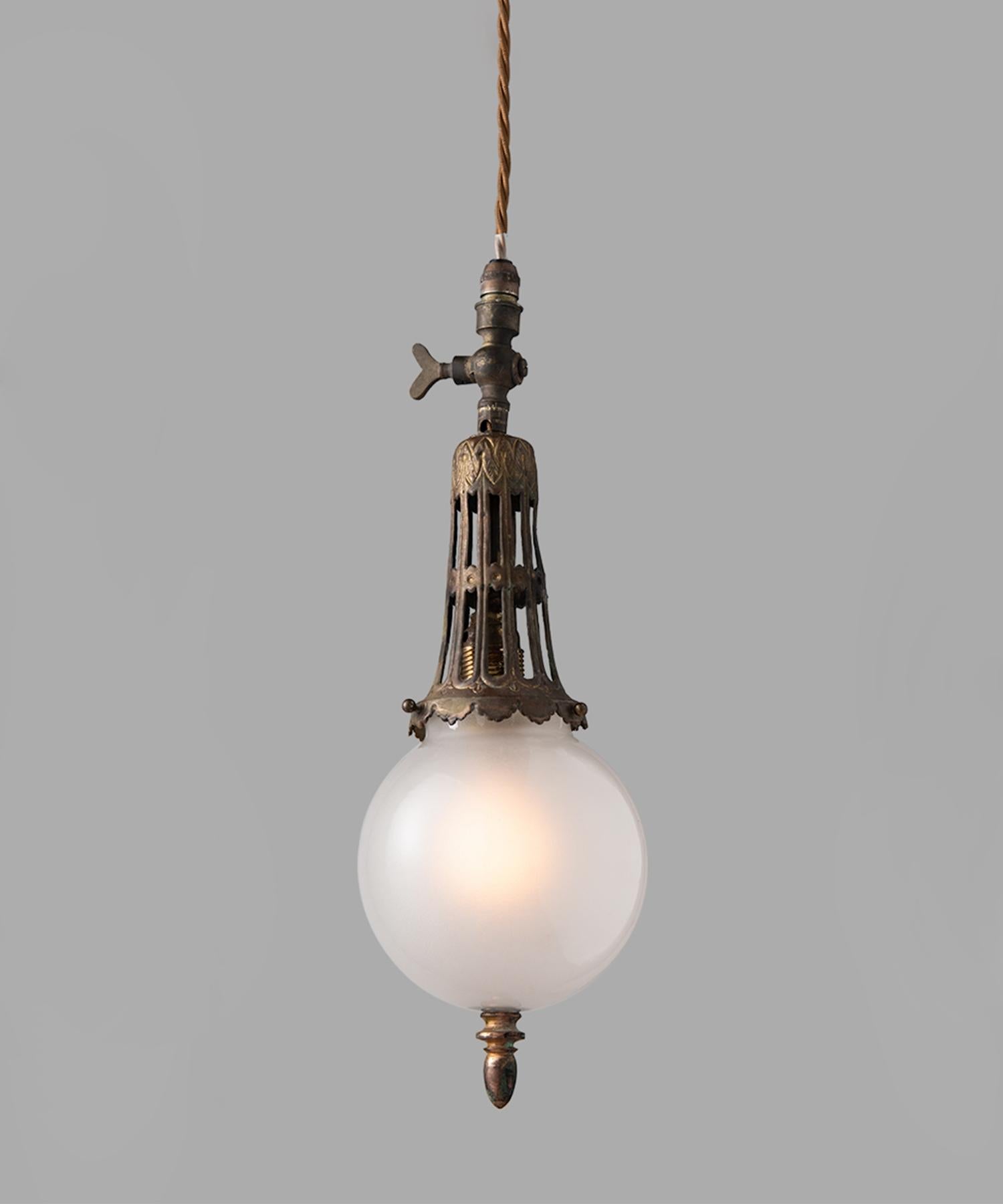 Art Nouveau gas lamp pendants, England, circa 1890.

Petite pendant with ornate brass fitter and switch, with translucent opaline glass shade.

Measures: 4.25” diameter x 14.5” height (adjustable drop).