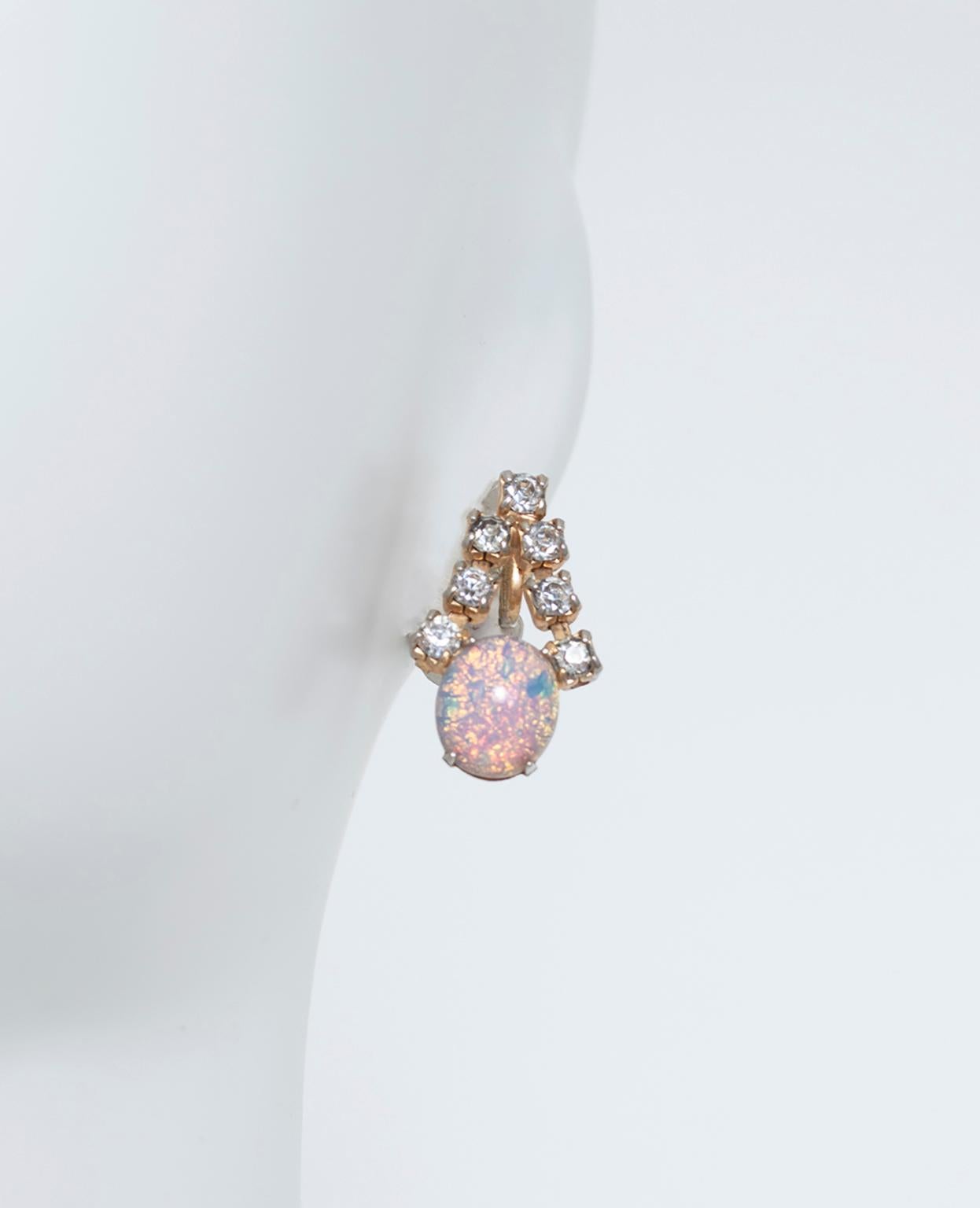 Neither buttons or dangles, these luminous earrings feature an inverted “V” of rhinestones punctuated by a perfect 12 mm opal cabochon. Petite yet statement-making and thoroughly mesmerizing.

Earrings featuring seven 4 mm rhinestones arranged in an