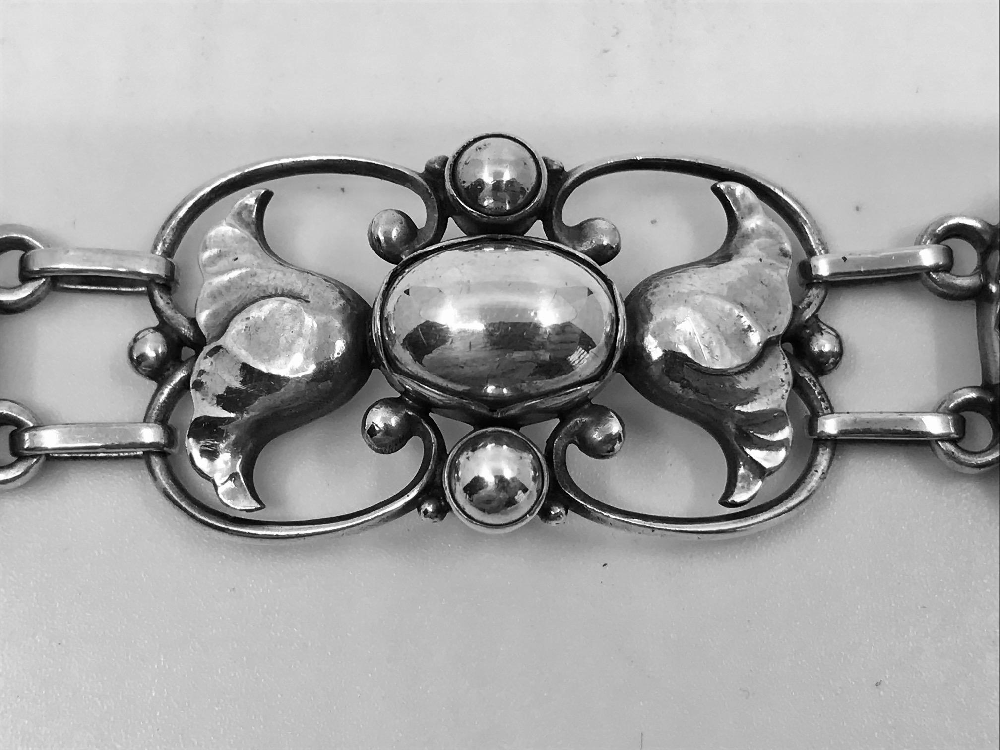Sterling silver Georg Jensen bracelet with floral details and large silver beads, design #34 by Georg Jensen from the 1920s. The large links are curved for a better fit.

Measures 7 1/4″ in length, the links are 7/8″ (18.5cm, 2.2cm).

Post 1944