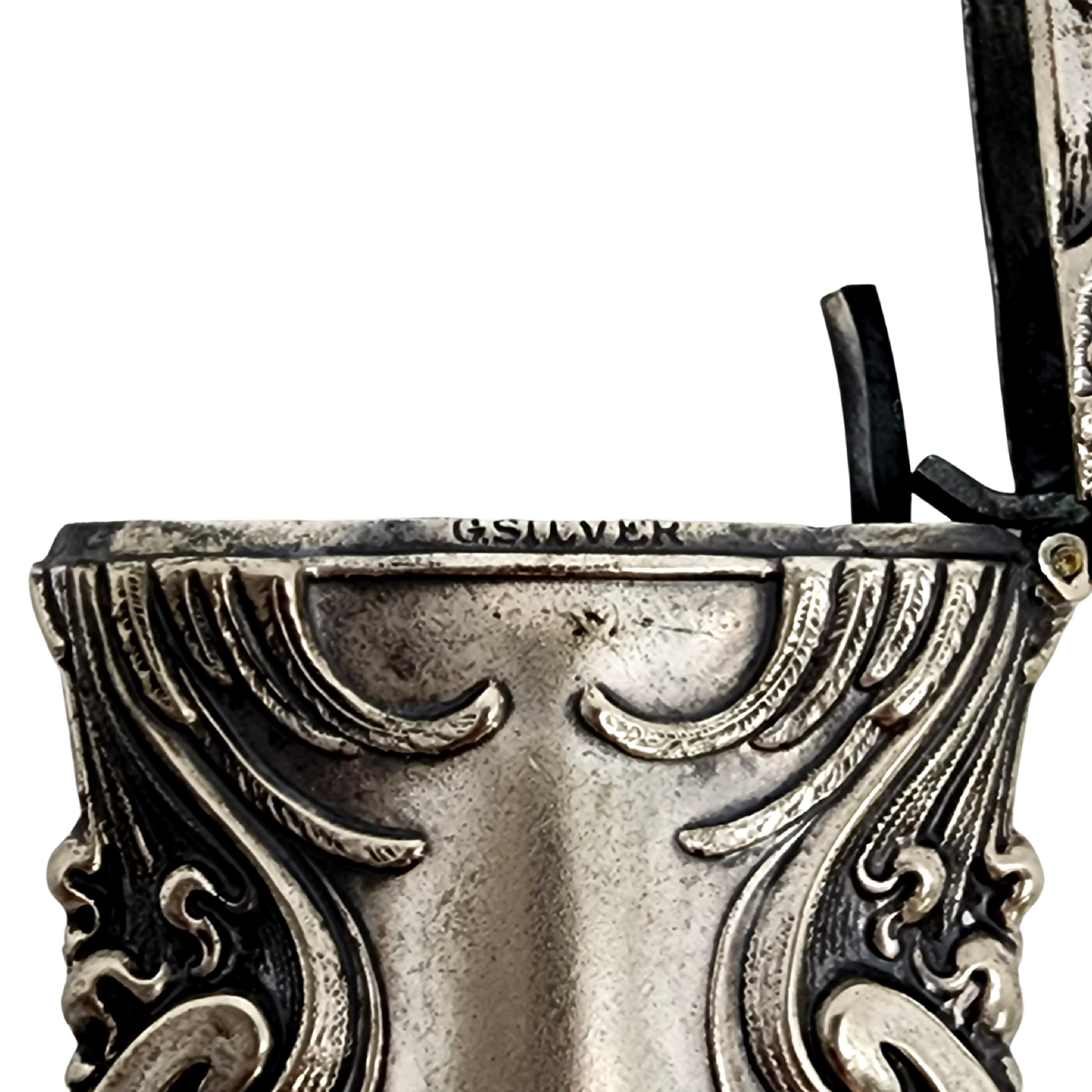Art Nouveau German silver match safe/vesta case.

This beautiful piece features a repousse design of swirls, scrolls, and leaves. It has a well functioning hinge, and a striking surface on the bottom. German silver has no silver content.

Measures