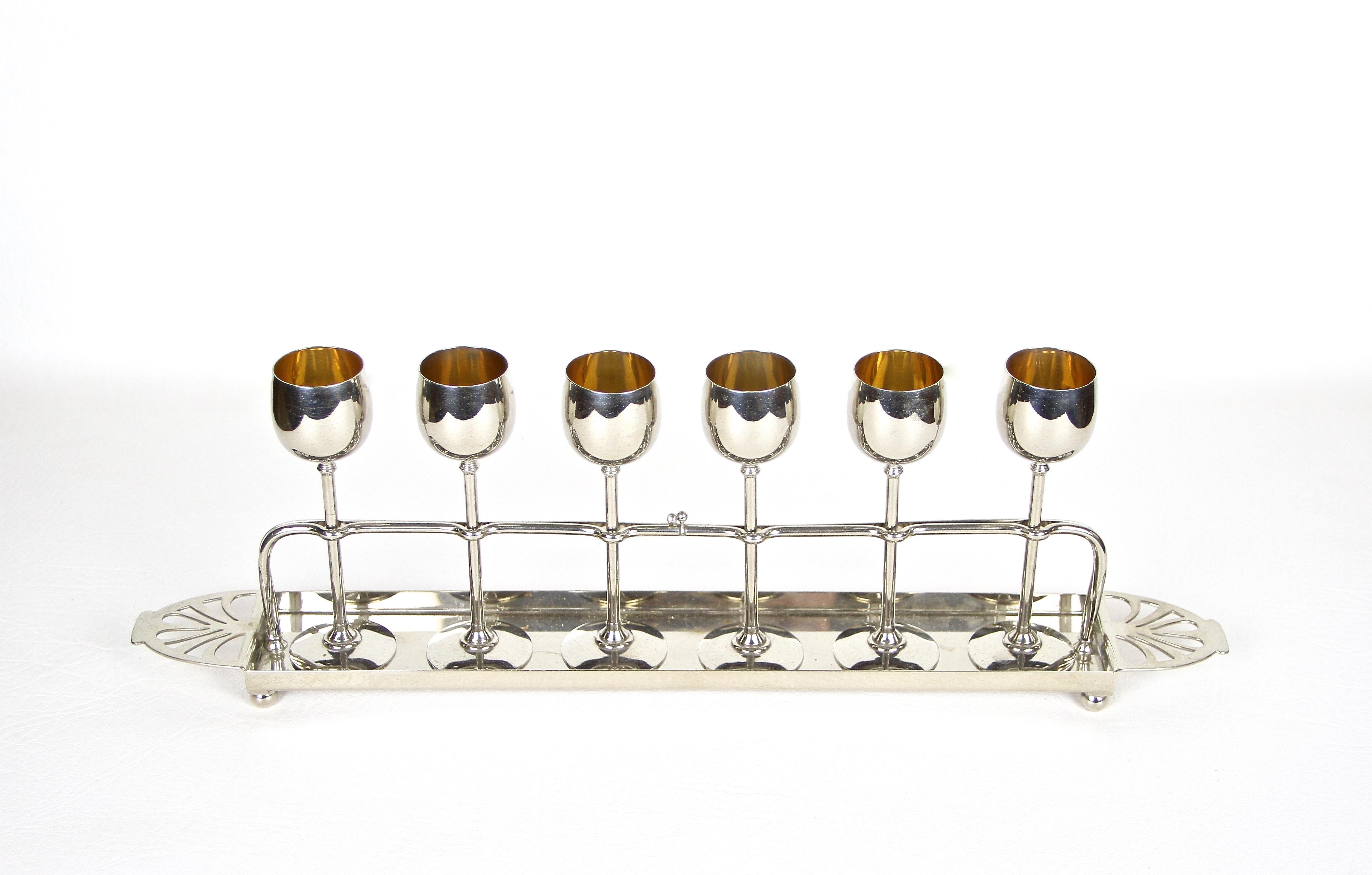 Superb Art Nouveau Liquor set from the period around 1910 in Germany made by the renown company of WMF. An outstanding liquor set consisting of six lovely shaped goblets, set on an artfully designed nickel plated metal stand. All glasses are fixed