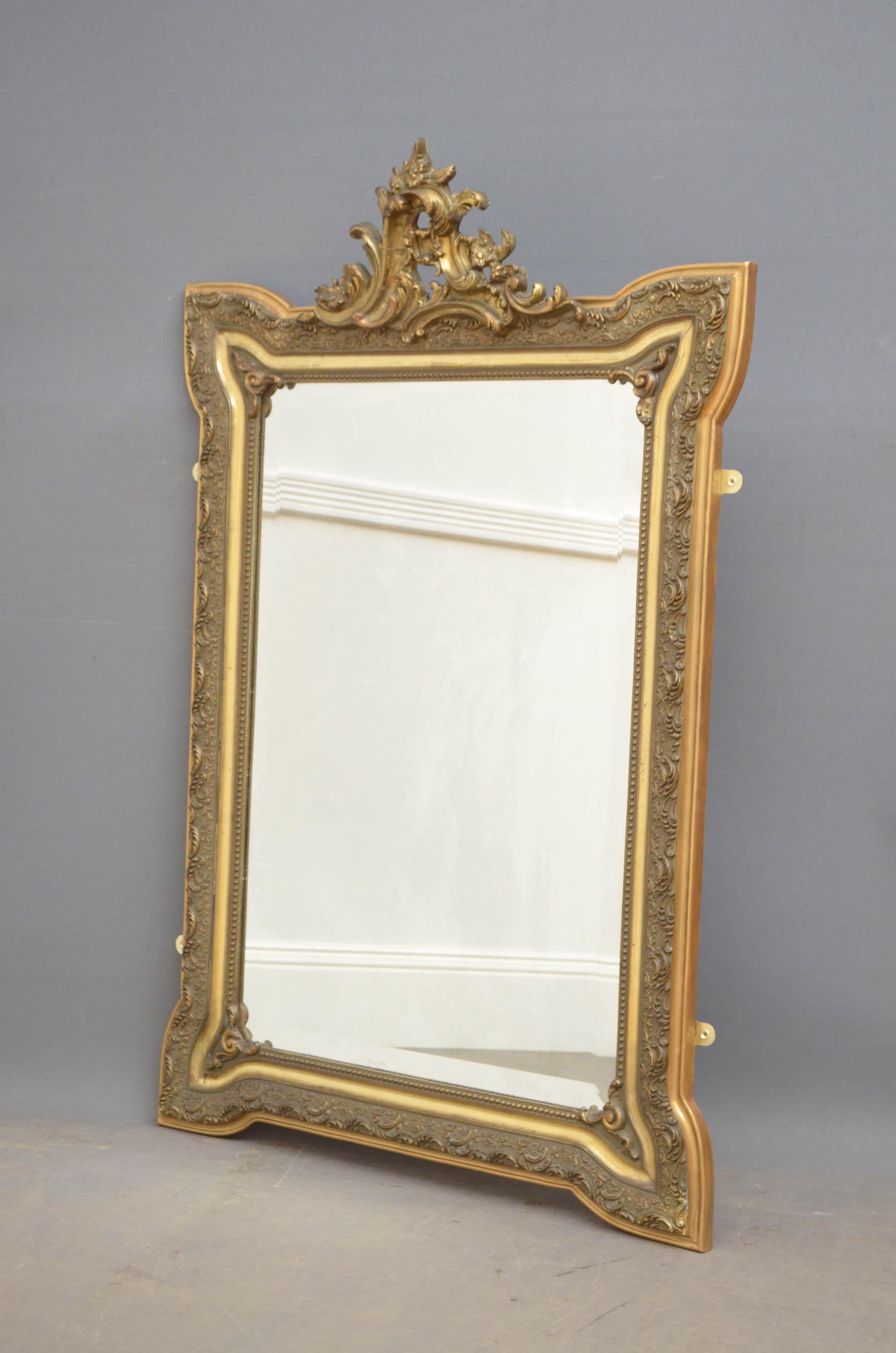 Sn4792 Art Nouveau glided wall mirror, having original bevelled edge, foxed glass in carved and moulded frame with centre crest to the top.

This antique mirror retains its original glass and gilt (with some touching up), it is in excellent home