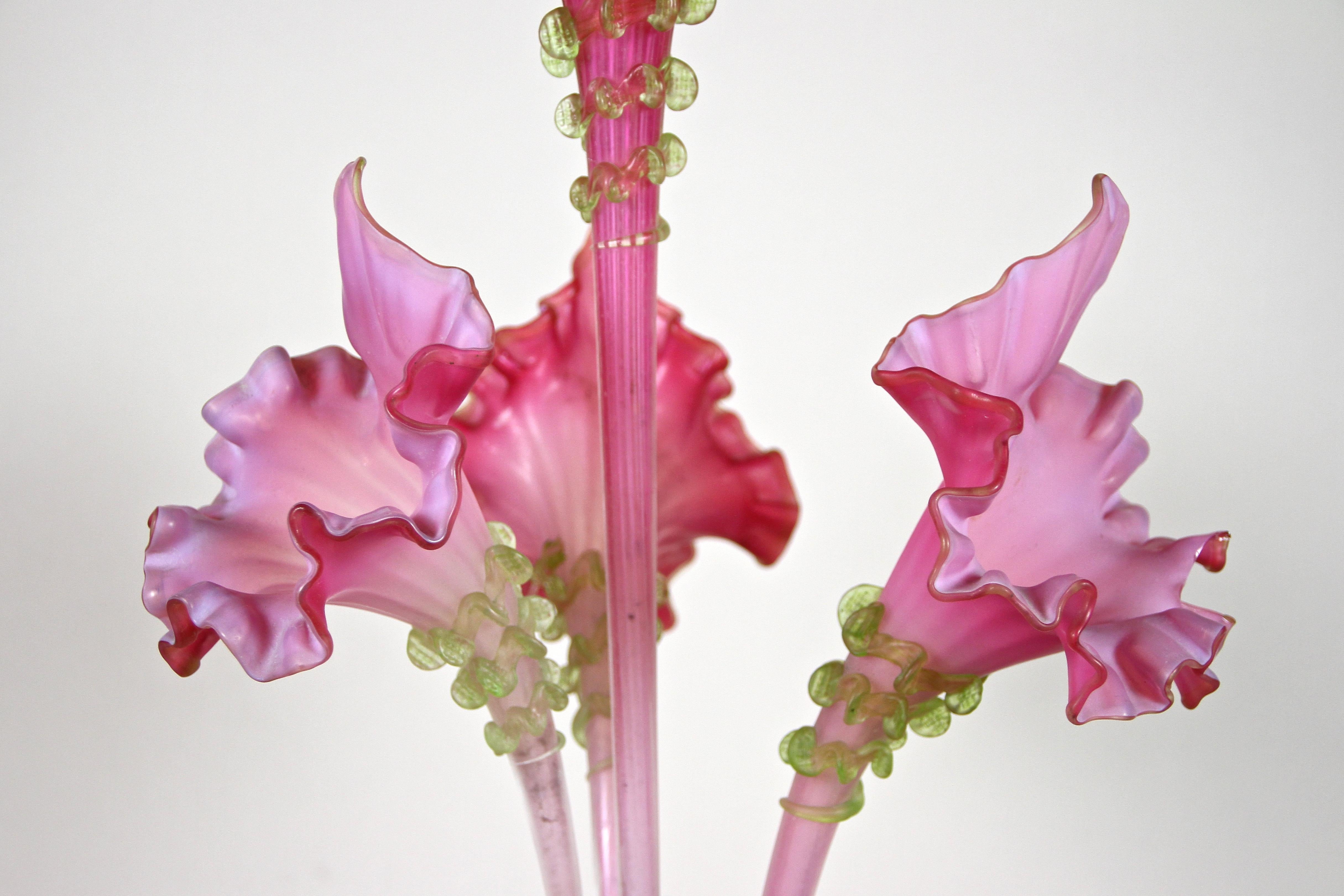 Amazing Art Nouveau glass flower centerpiece made in Austria around 1900. An absolute extraordinary designed centerpiece with three artfully worked, plugged pink frilly glass flower vases and a larger one which is screwed in the center. Every flower