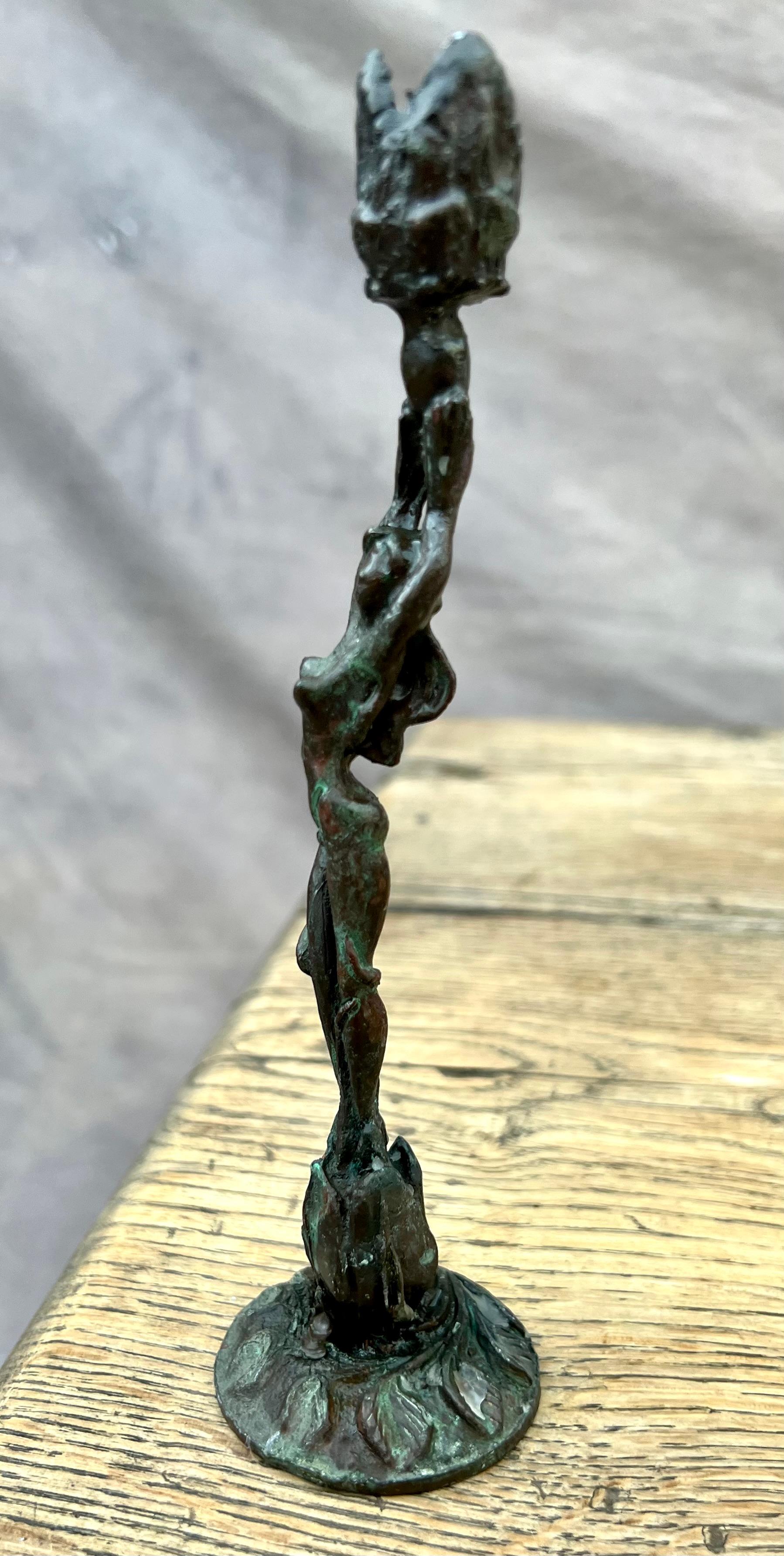 Expressive female figurine candlestick holder. 

The perfect table accent for a cozy dinner party, or in community with other candlesticks. Or perhaps bring a bit of Venus candlelight energy to the bath. Gorgeous patination on this delicately