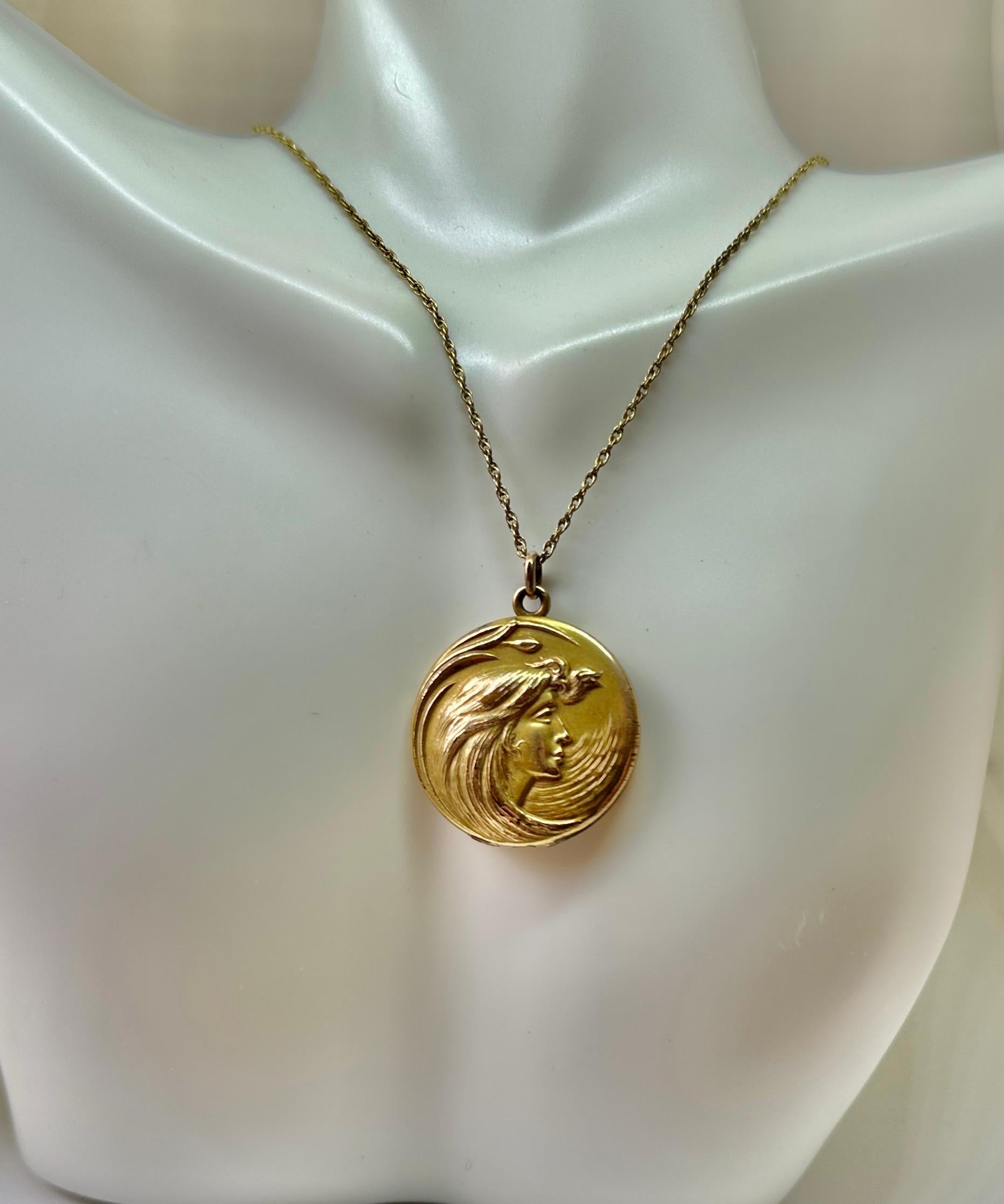 This is a gorgeous antique gold filled Victorian - Art Nouveau locket pendant necklace which features a beautiful goddess maiden woman with extraordinary flowing hair.  This is one of the most beautiful images of a goddess woman we have seen on a