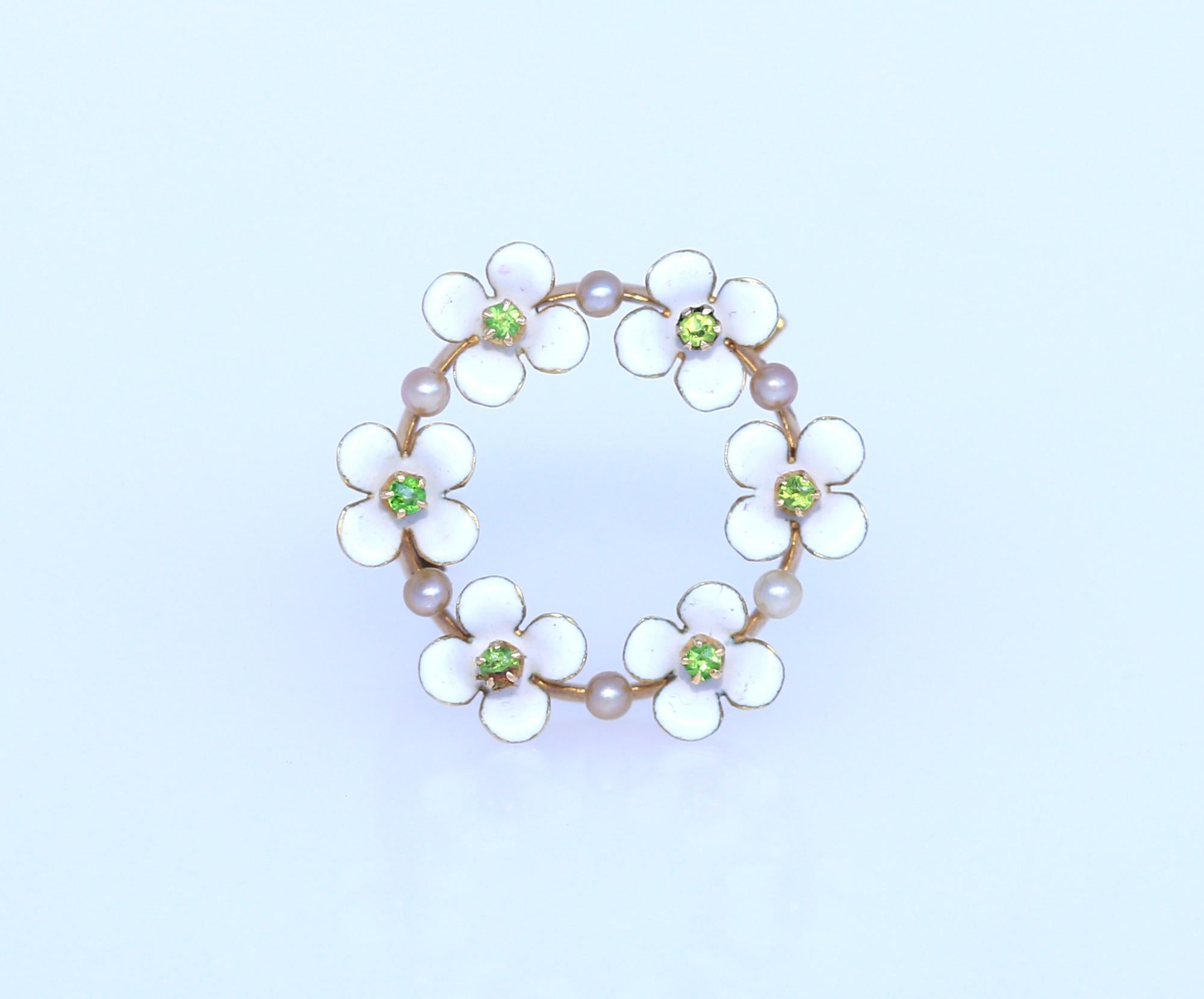 14K Gold White Enamel flowers with Peridot and Pearls a true Art Nouveau brooch. Europe 1920.
Once it was common to communicate a message via pin or brooch. Nowadays this art is lost, but we can surely start a new tradition. White flowers and green