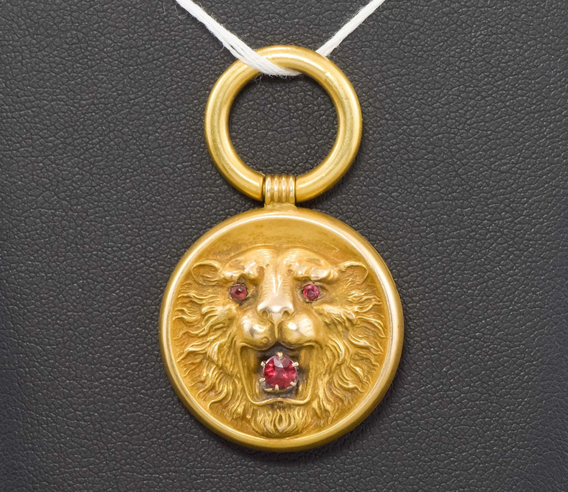 Dating to the Art Nouveau period, this handsome and dimensional gold Lion was originally worn as a pocket watch fob with ribbon - now he makes a wonderfully charming pendant.

Beautifully detailed in the repousse method, the Lion's open mouth holds