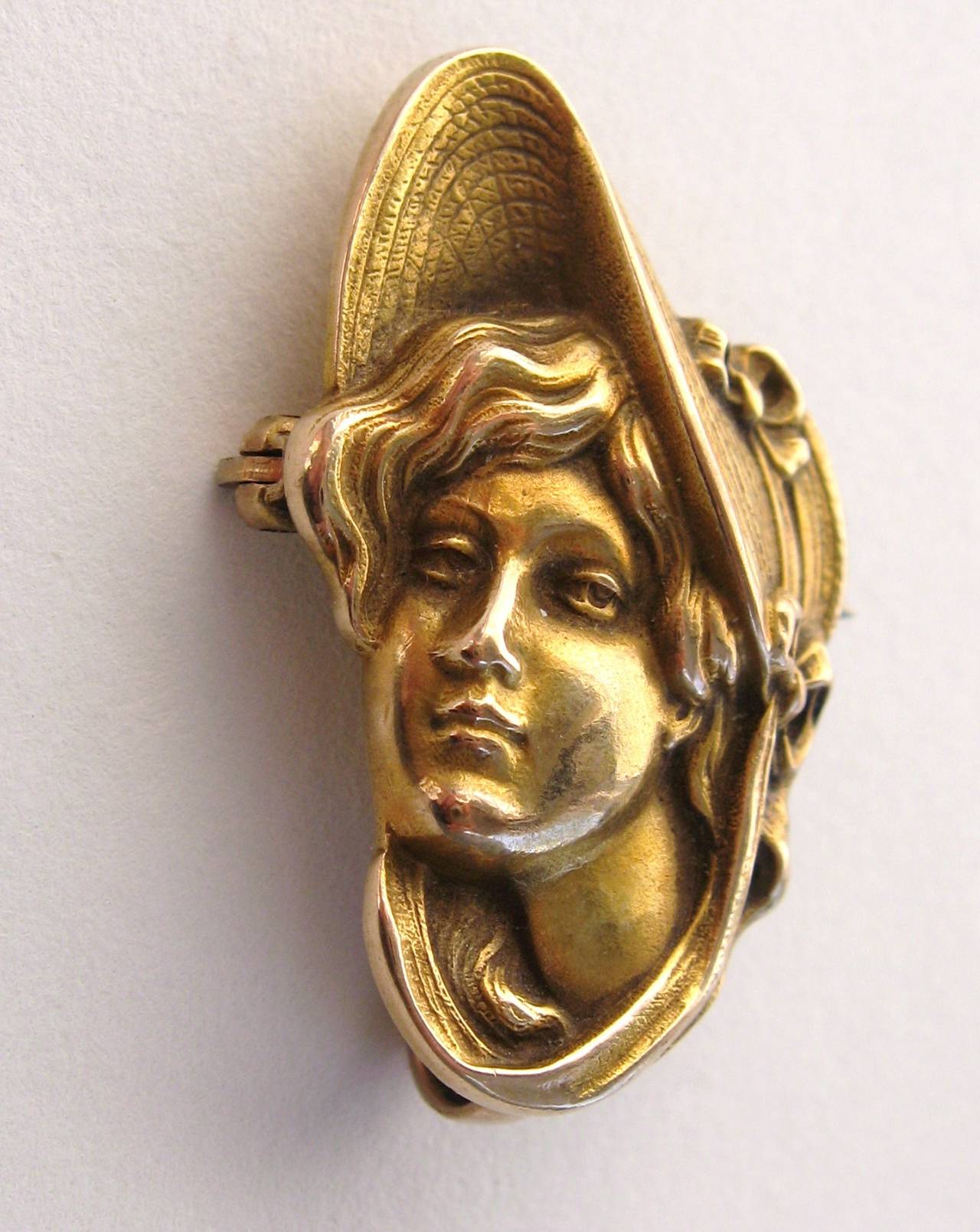 Vintage art nouveau circa 1900s Profile of a women brooch pin. Lovely lady in a bonnet. You can attach a chain to the back to wear as a pendant. Crafted in 10  karat yellow gold. Measures  1.22