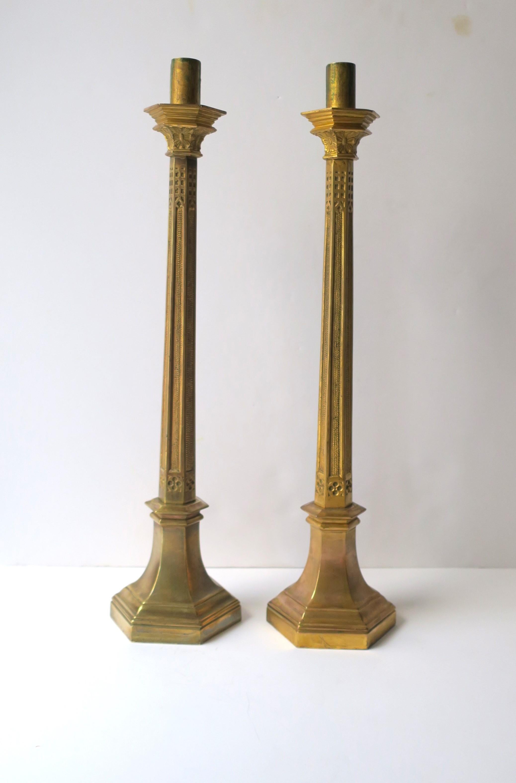 A substantial, beautiful and tall pair of Art Nouveau and Gothic style brass candlestick holders, circa early-20th century. A solid tall pair with beautiful, subtle details of both Art Nouveau and Gothic design styles, as shown in images. Pair may