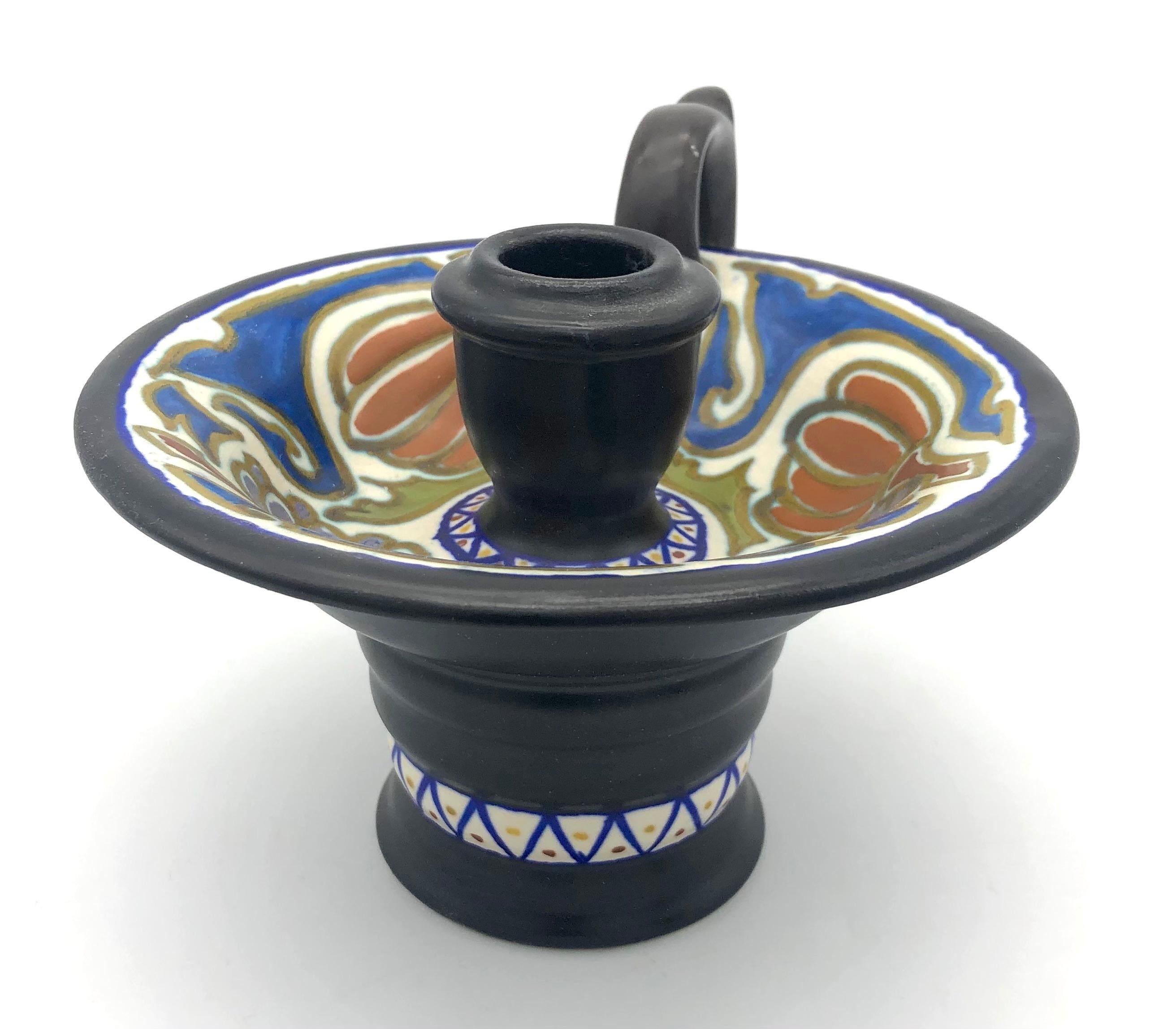 This candleholder was executed by a Dutch studio pottery Gouda in 1913.
