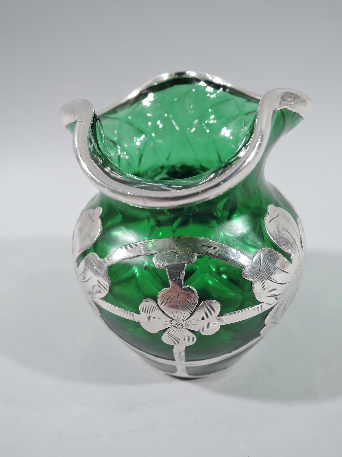 Turn-of-the-century Art Nouveau quilted green glass bud vase by historic maker Loetz with engraved silver overlay. Globular with trefoil ruffled rim. Silver overlay in form of garland with alternating flower heads and stem flowers set in oval frame.