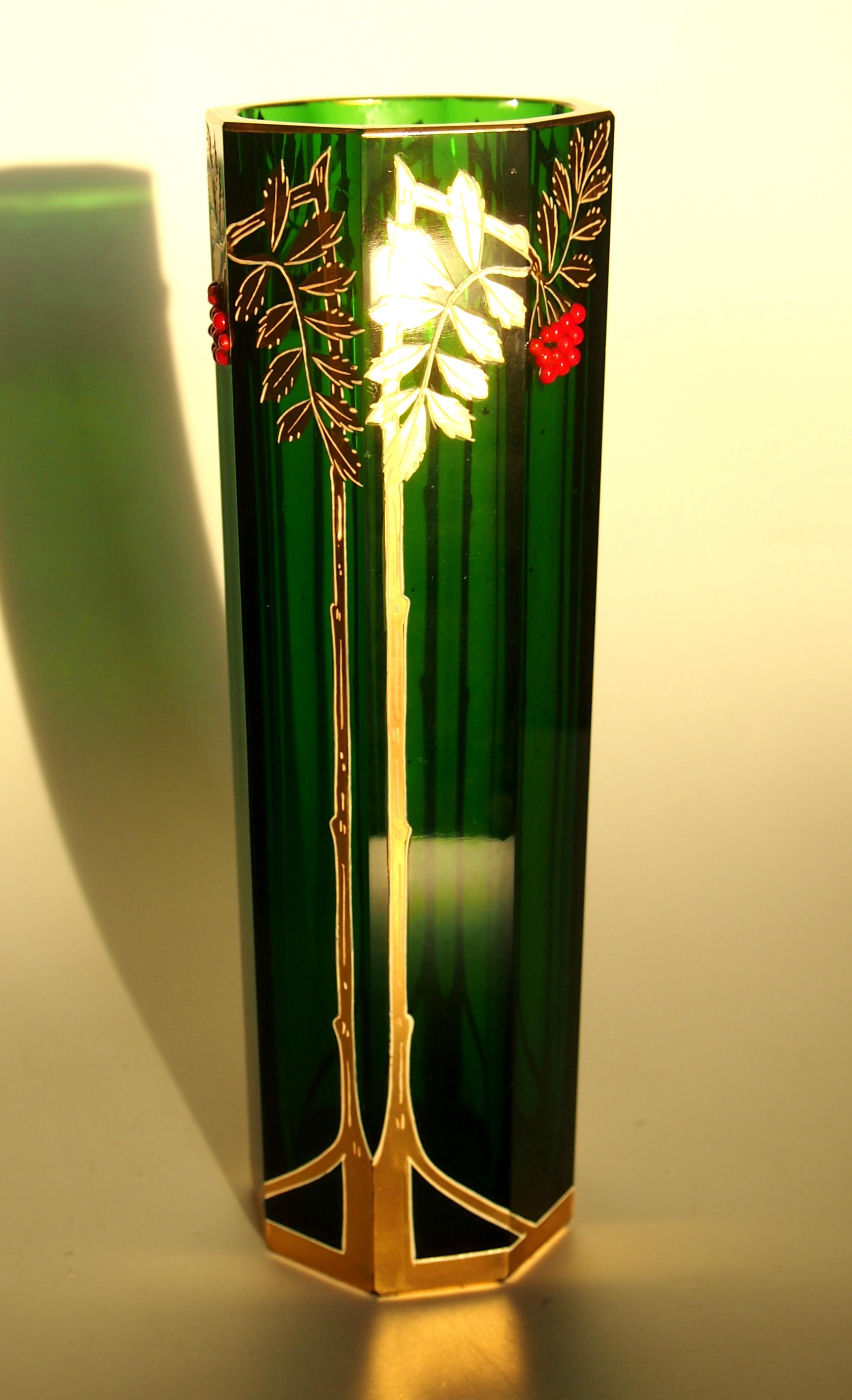 A super octagonal Riedel vase in green with gilding over white enamel and tiny applied red glass beads. Riedel used a combination of the European styles of the time merging elements of Art Nouveau, Jugendstil and Vienna Secessionism. The little