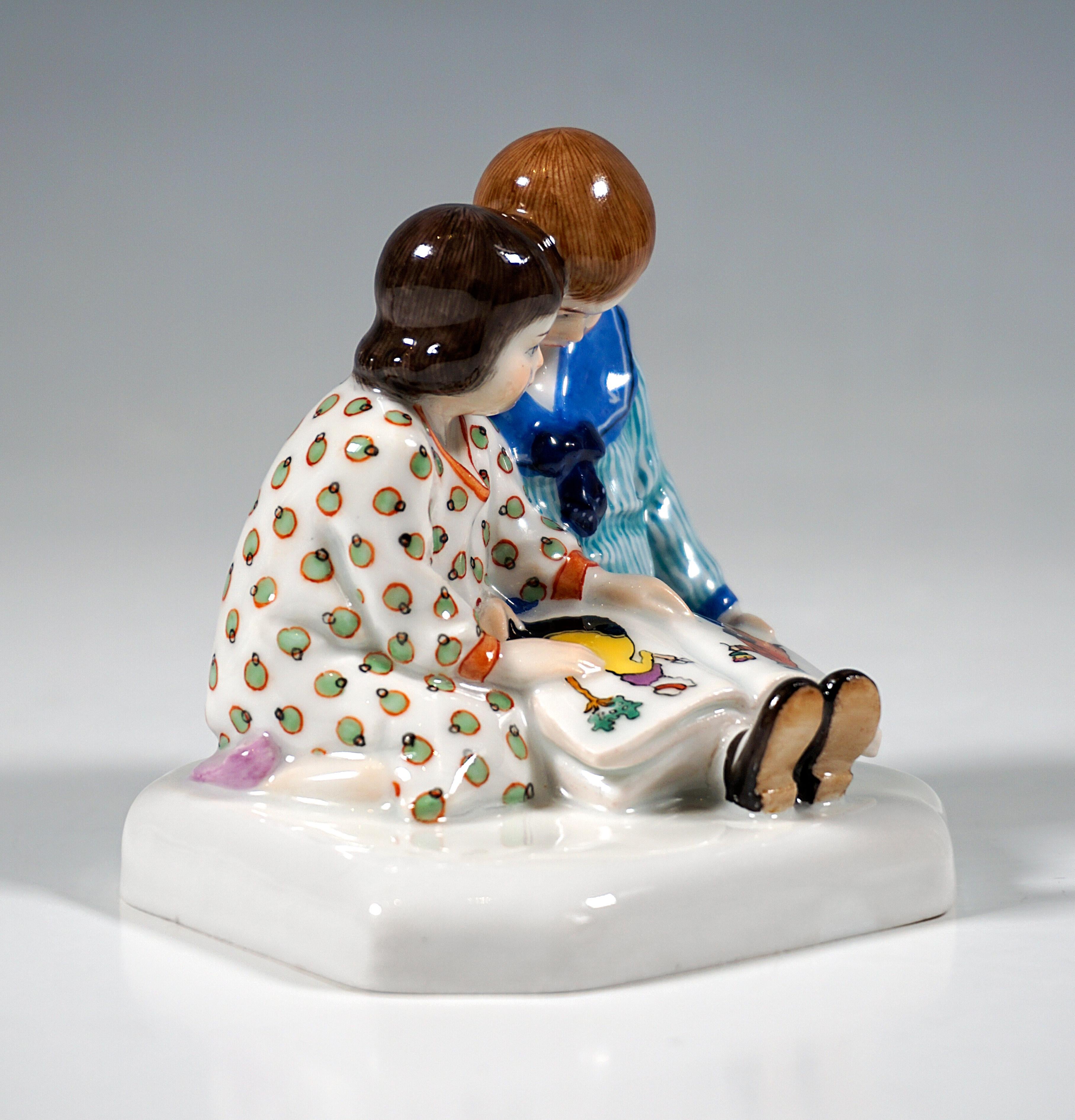 Extremely rare Meissen Art Nouveau porcelain group:
A boy in a sailor suit sitting on the floor with outstretched legs, a large picture book on his lap, next to him, head to head, a kneeling girl in a dotted dress, pointing to a picture.
Based on