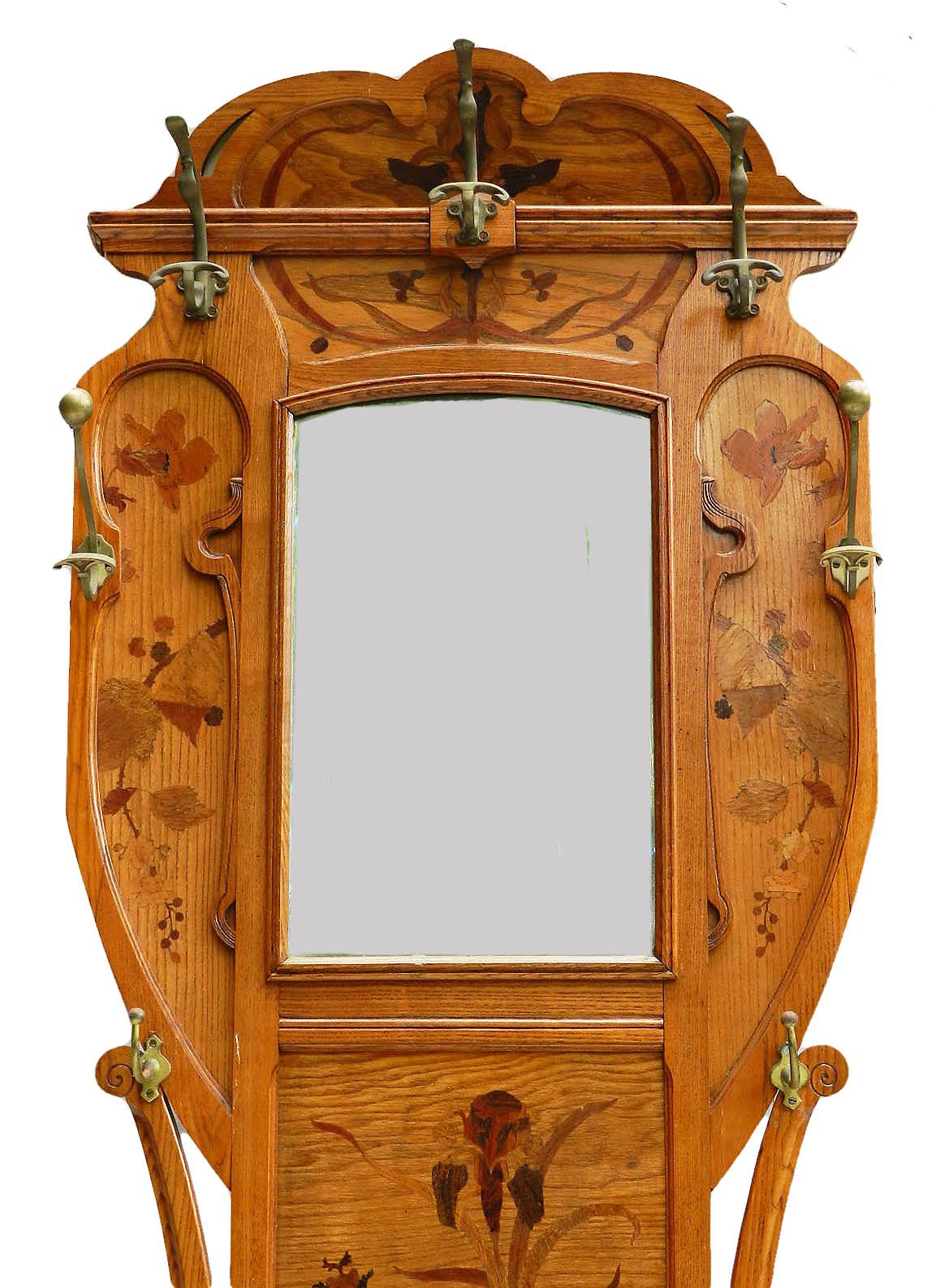 Coat rack hall stand Ecole de Nancy manner of Majorelle
Pitch pine
Inlaid Marquetry with Irises and foliage of various different woods
Original beveled mirror in good condition
Good antique condition with some old restorations and 2 replacement coat