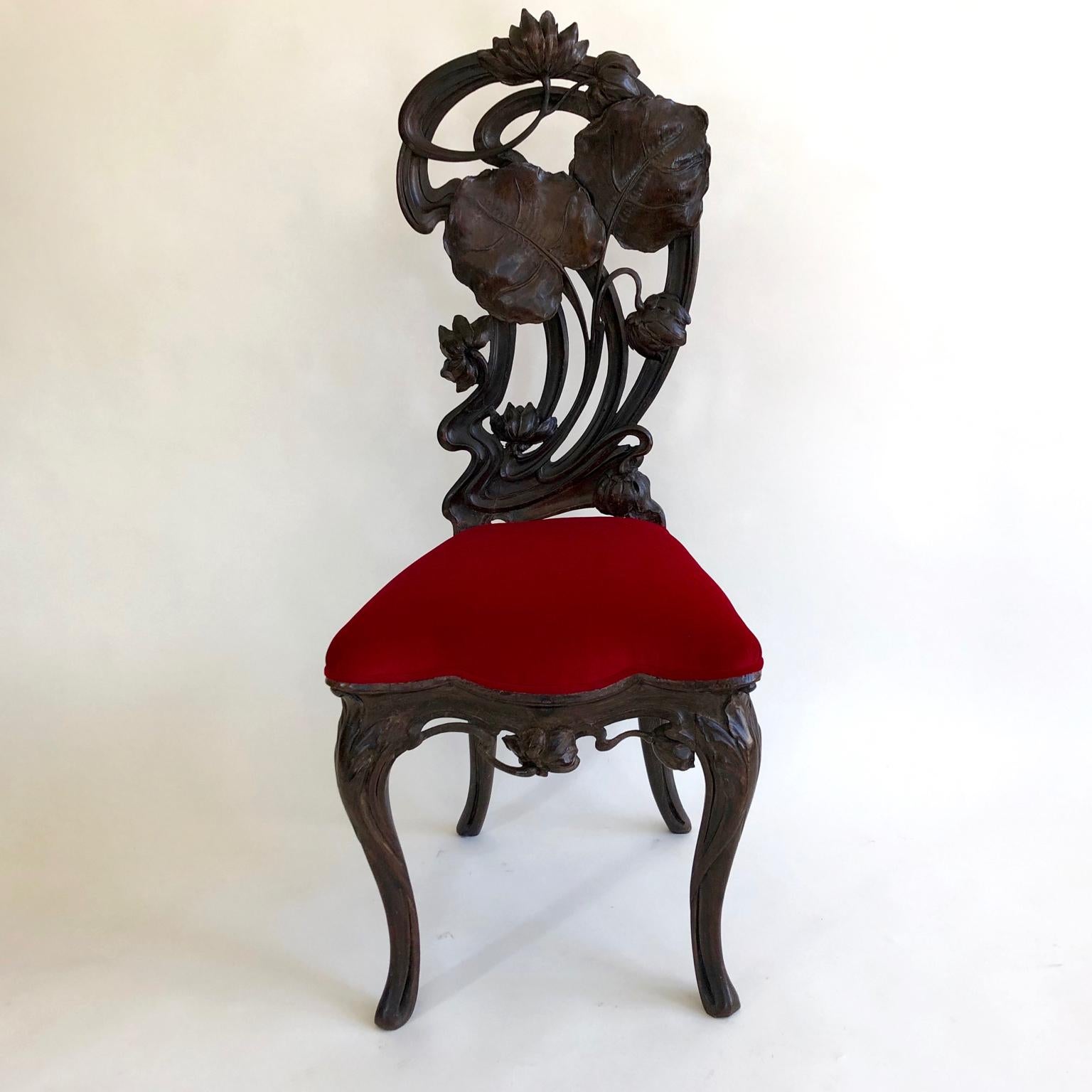 European Art Nouveau hand carved hall chair with a red velour or velvet seat.