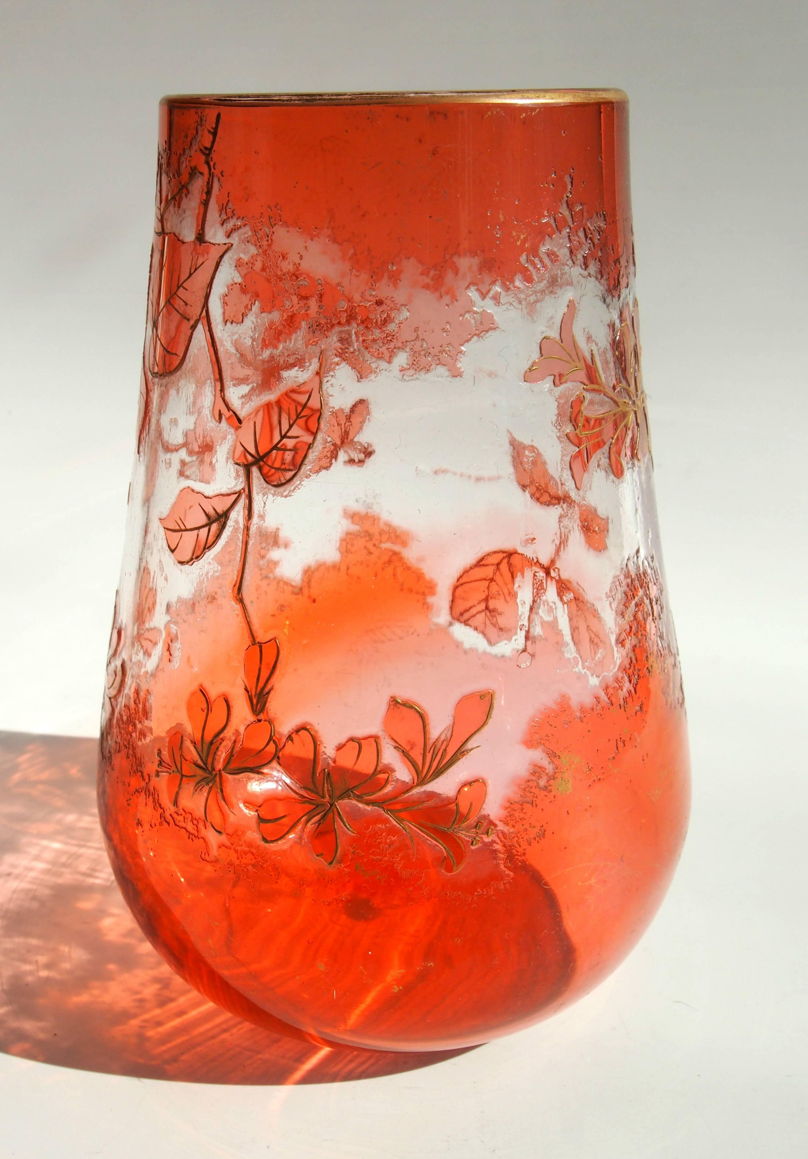 A vibrant Art Nouveau orange/pink over clear Harrach cameo vase. Depicting flowers highlighted with gilding. This style of Cameo was taken by Harrach to the 1900 Paris exhibition. Their stylized cameo technique employed an icicle effect -visible