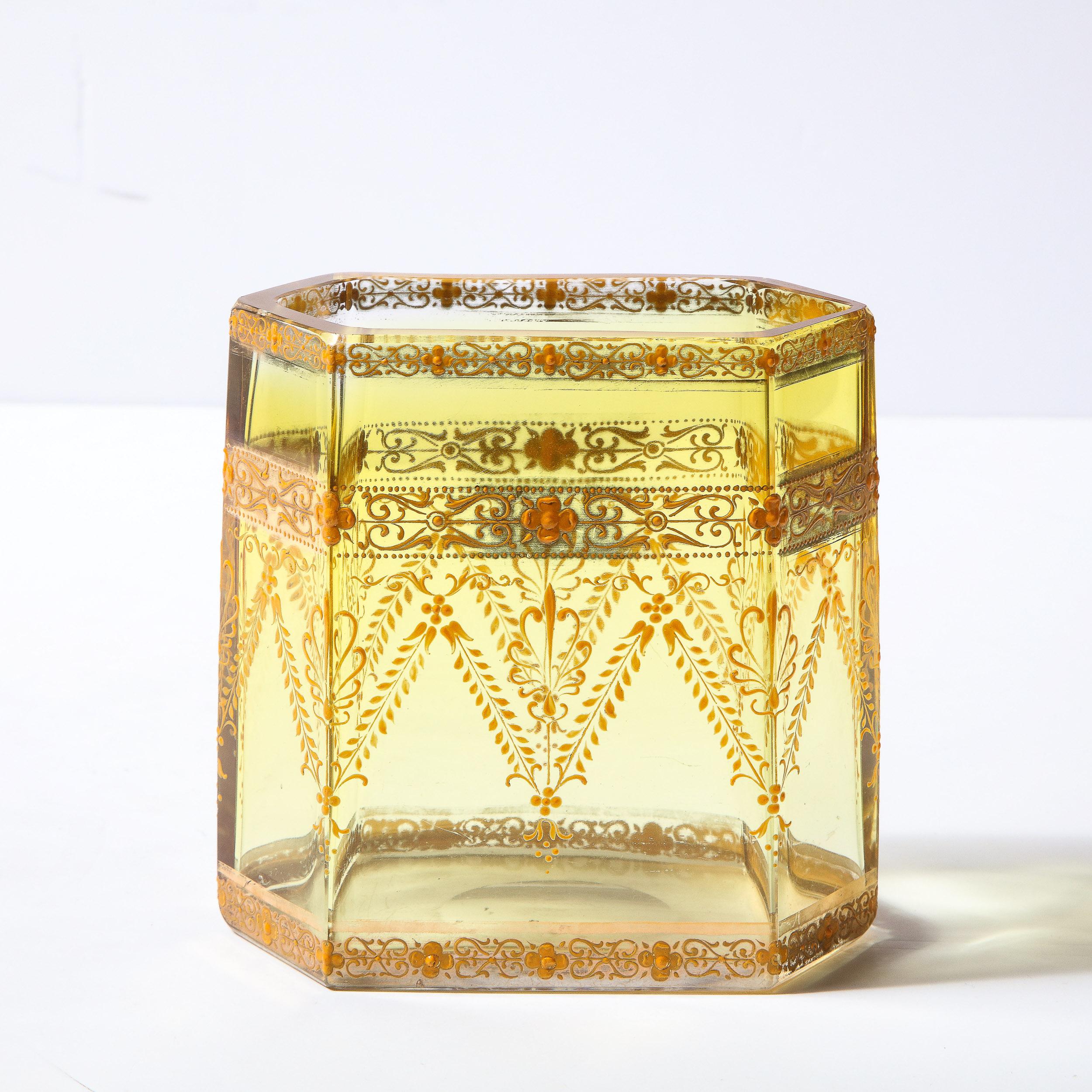 This elegant and sophisticated Art Nouveau Vase/ vessel was realized by the esteemed studio of Moser in Czechoslovakia circa 1910. It features an elongated hexagonal shape in amber tinted glass. The exterior offers a wealth of neoclassical forms-