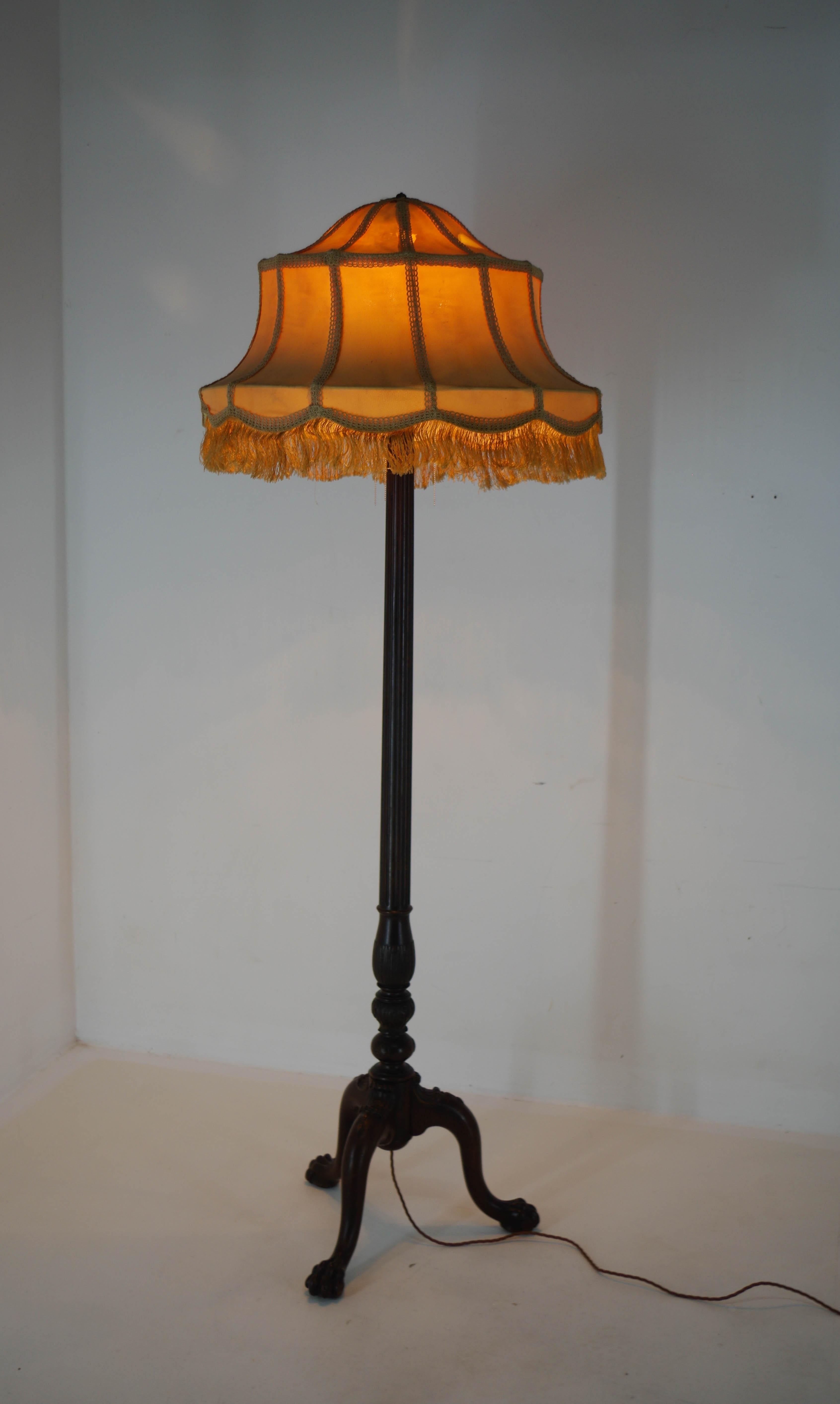 Big Art Nouveau floor lamp. An eye-catching piece with a beautiful patina and warm ambient light. 
Wooden stand with good condition and original fabric shade in fair condition with some damage visible on pictures.
Item was newly rewired, it is