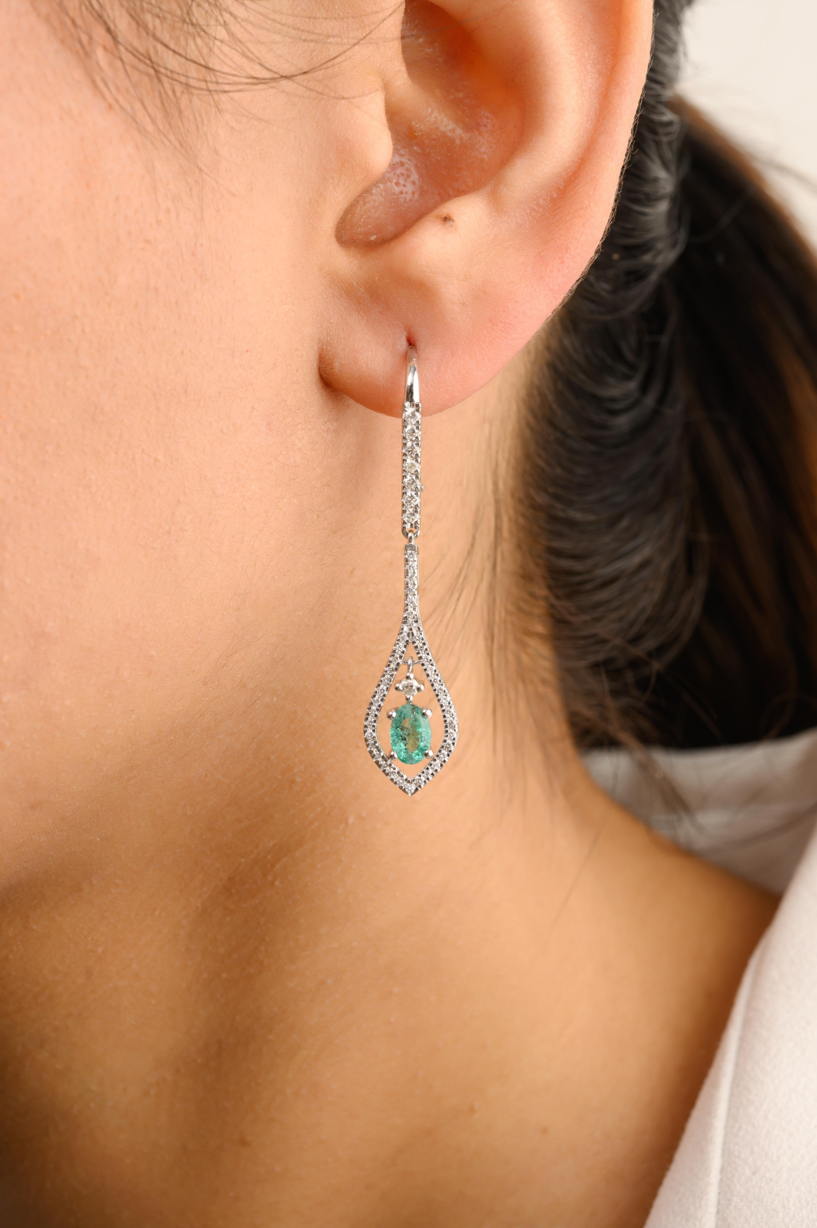 Art Nouveau Style Emerald Diamond Dangle Drop Earrings in 14K Gold to make a statement with your look. You shall need dangle earrings to make a statement with your look. These earrings create a sparkling, luxurious look featuring oval cut emerald