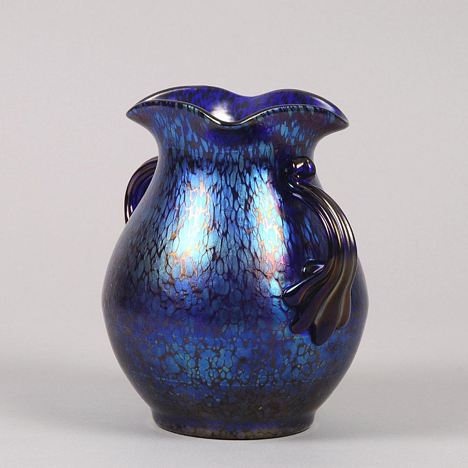 A very fine late 19th century Art Nouveau twin handled blue glass vase of bulbous form with petrol blue oil spot iridescence, with excellent detail and color.

The Loetz glassworks existed in Klostermuhle, Austria, for just over a hundred years,