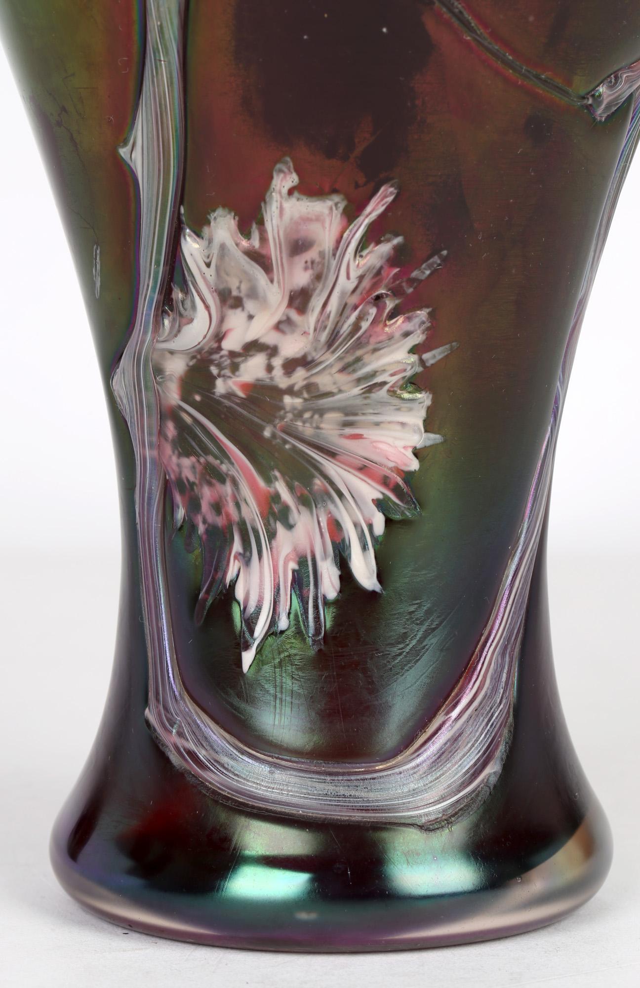 A large and exceptional Bohemian Art Nouveau iridescent glass vase applied with flower head designs by Pallme-Konig dating from around 1900. This tall elegant vase is applied with trailing pink and white stems with abstract flower heads against an