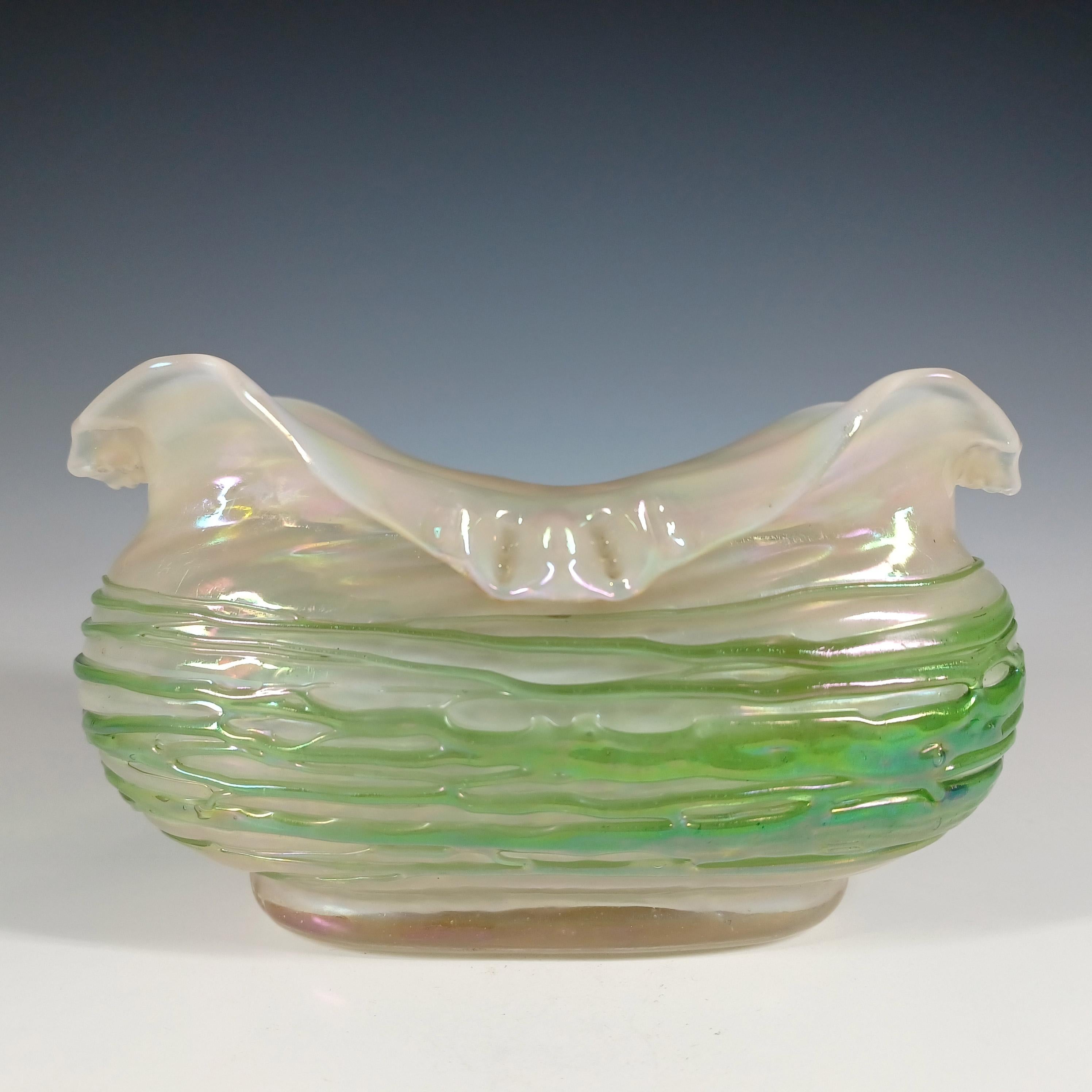 Here we have a beautiful Bohemian mother-of-pearl glass vase with green threading, from the late 19th century art nouveau period. Has a stunning oily, iridescent finish. Manufacturer unknown.

Size
Measures approx 3.5 inches tall by 6.25 inches in