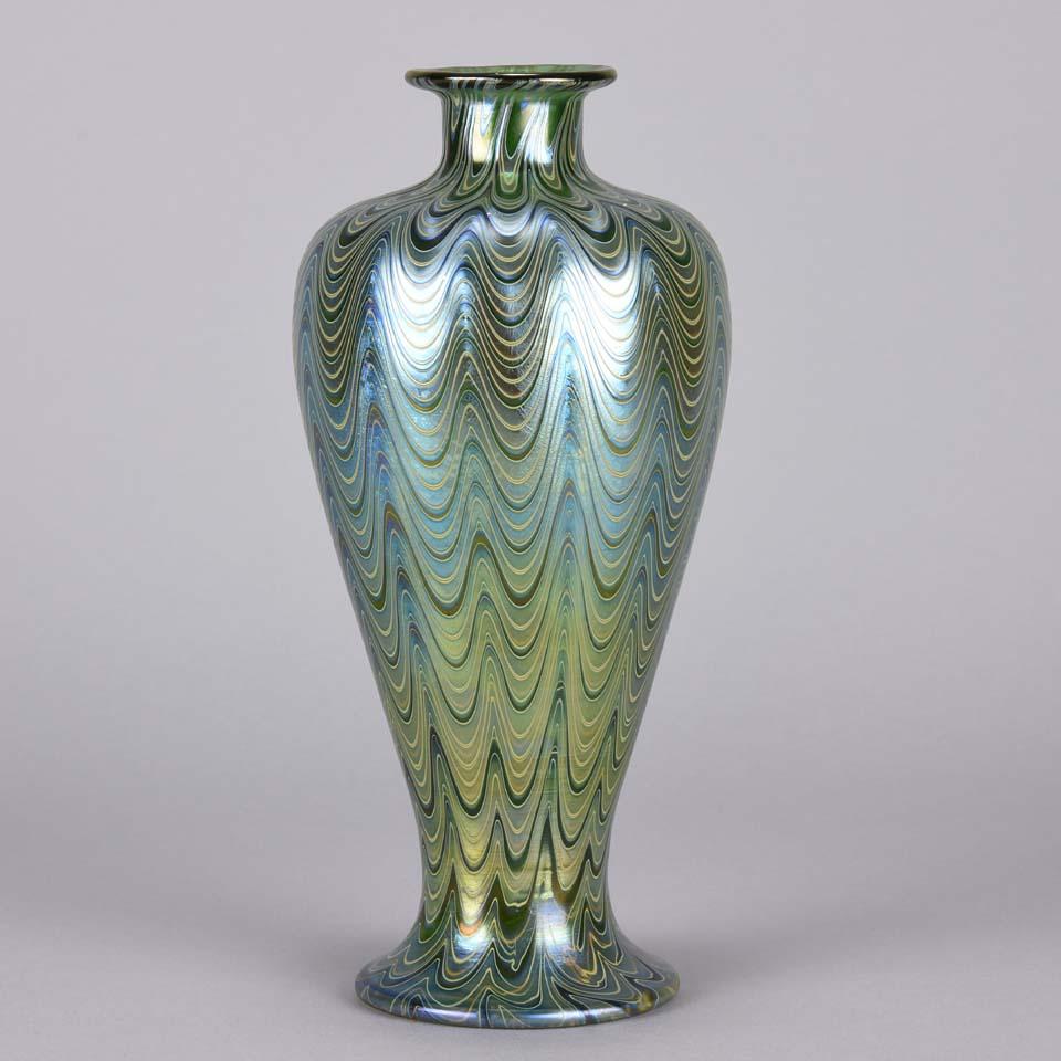 Impressive late 19th century Austrian lime green glass vase overlaid with petrol blue casing and finished in a lava phanomen decoration

The Loetz glassworks existed in Klostermuhle, Austria, for just over a hundred years, starting from 1840. But