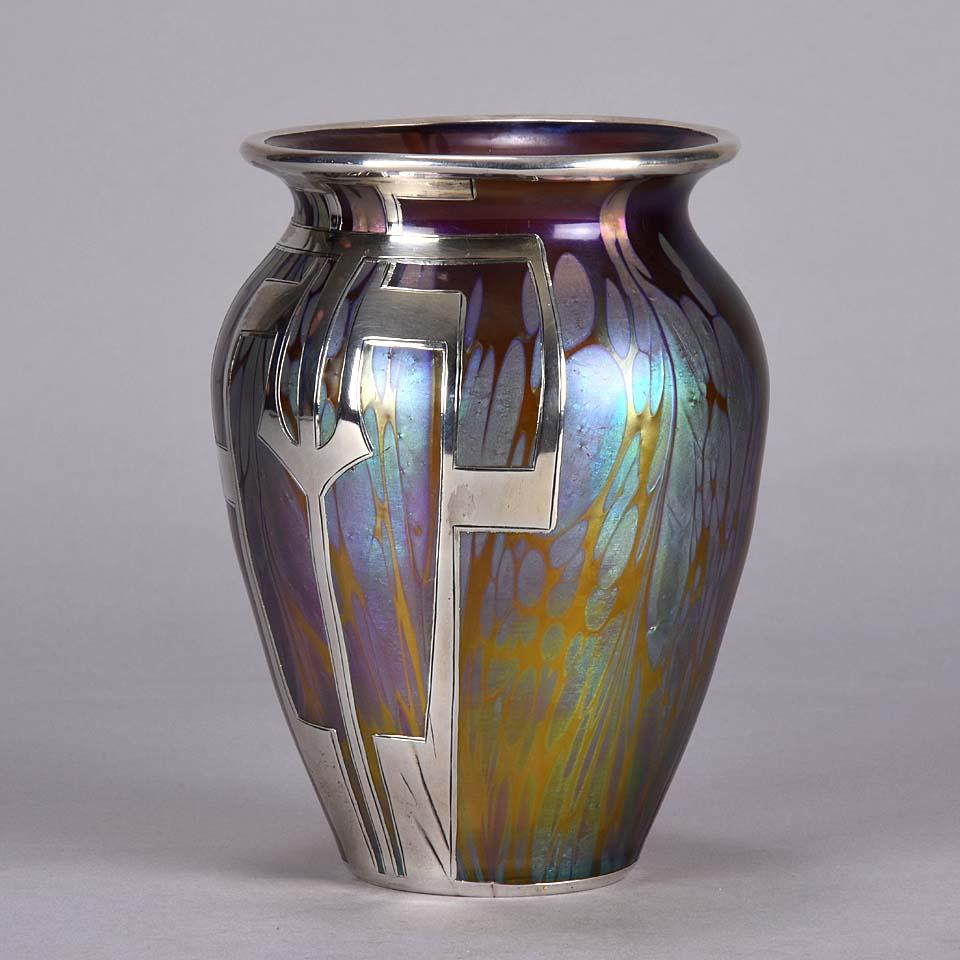 Magnificent early 20th century Medici Secessionist vase by Loetz Witwe, the iridescent pink and golden glass vase with a beautiful geometric applied silver decoration.