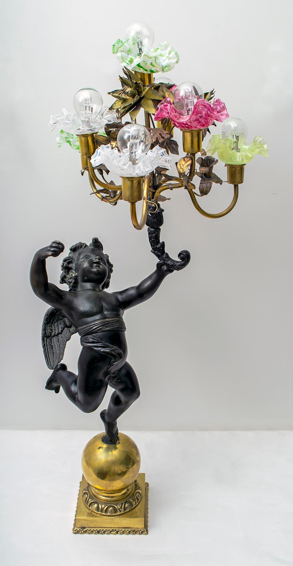 Beautiful antique liberty lamp in burnished and polished bronze, the bronze represents a winged putto, made with the lost-wax casting technique, (as in the photo is divided into two) with a bouquet of 7 handmade brass lights decorated with tulips in