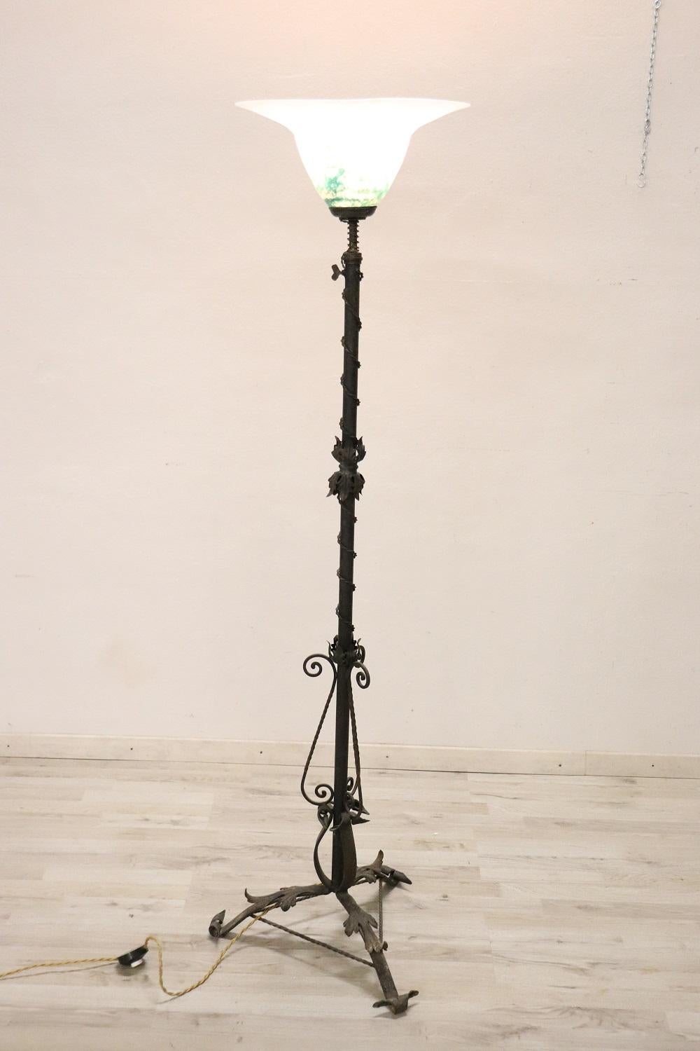 Beautiful art nouveau wrought iron and colored murano glass floor lamp. The body of this lamp is a true work of art in wrought iron with intertwined leaves. The iron has a nice old patina.